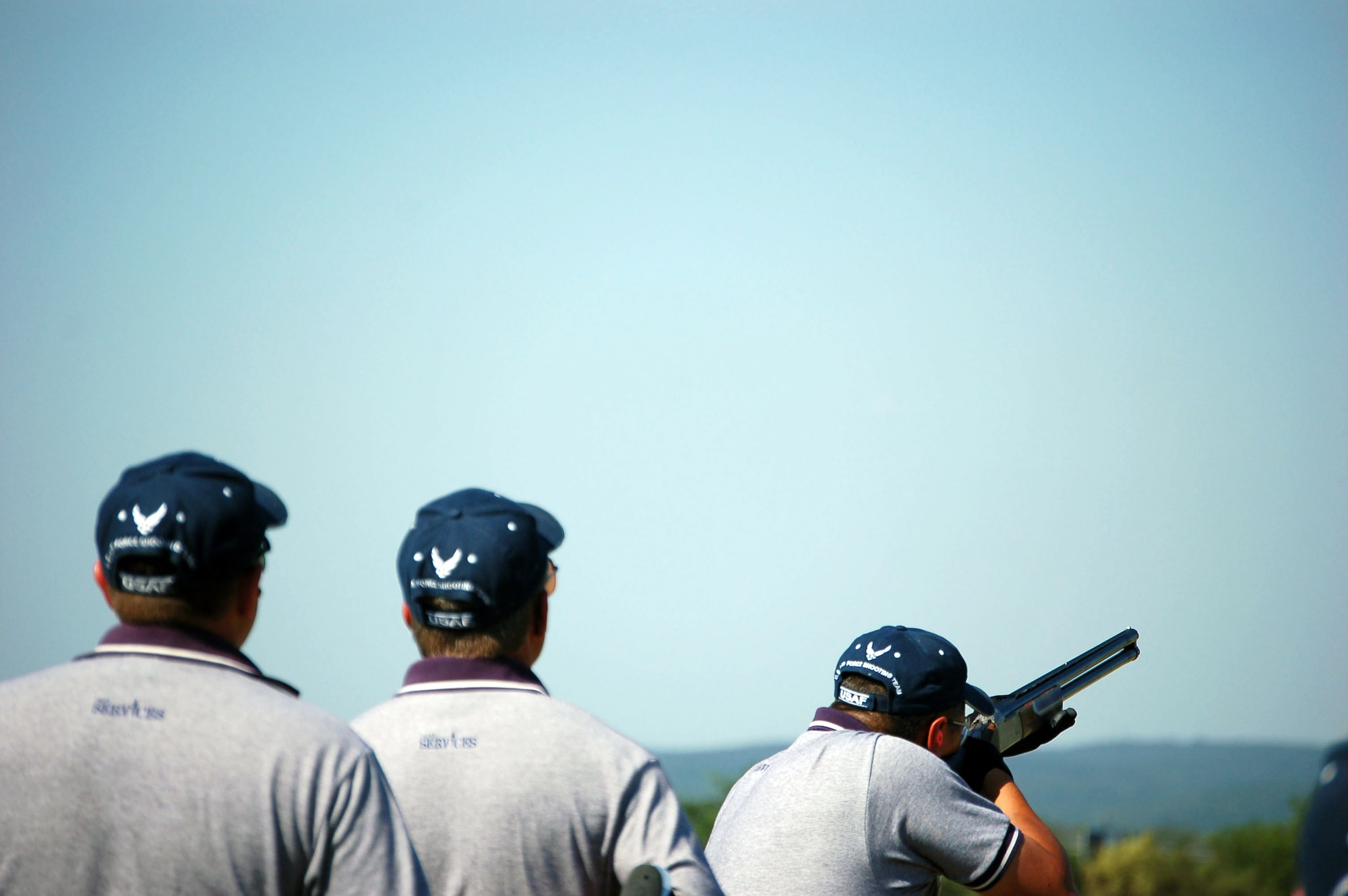 Capt. Brian Moore prepares to shoot at station 4, as Lt. Col. Rick Davis and Master Sgt. Mike Giese look on Oct. 12. Moore, Davis and Giese are members of Air Force Team One, who came in first among all the military teams at the that competed at the 2007 World Skeet Championship in San Antonio. (U.S. Air Force photo/Staff Sgt. Jeremy Larlee)