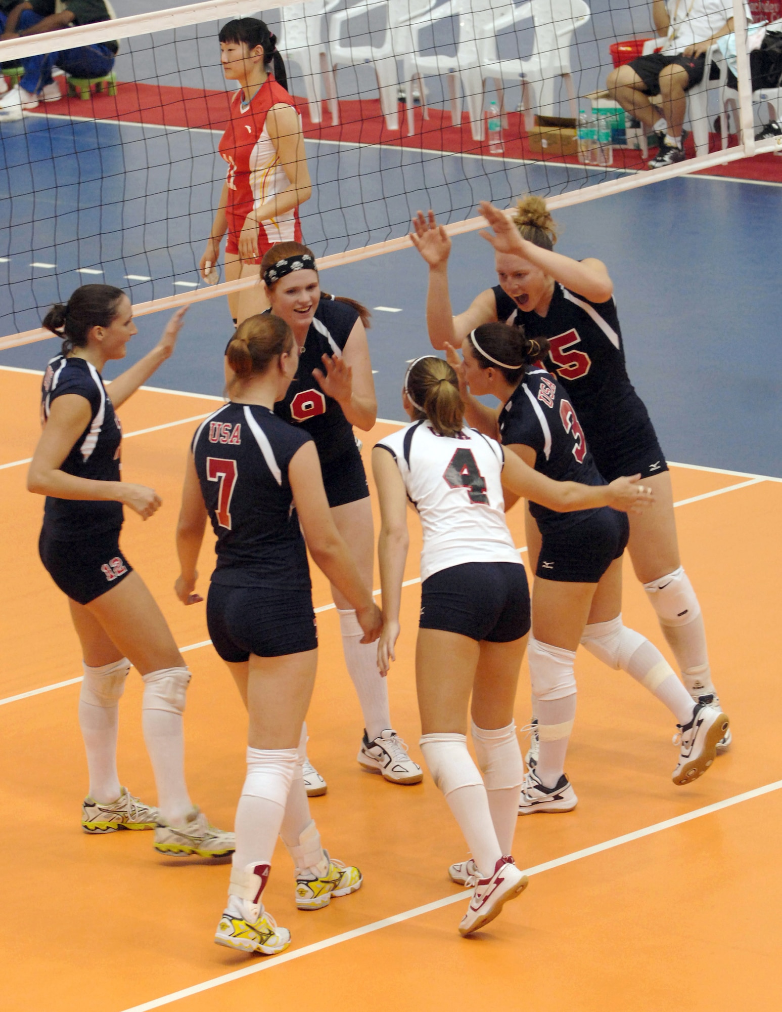The U.S. women' volleyball team celebrates a point during a match Oct. 14 against the Chinese team at the Military World Games in Hyderabad, India.  The U.S. women fell to the Chinese team in three games, 25-15, 25-11, 25-7.  The Conseil Internationale du Sport Militaire's Military World Games event is the largest international military Olympic-style event in the world.  In this year's fourth edition of the Games, 103 countries and more than 5,000 athletes are competing Oct. 14 to 21 in boxing, diving, soccer, handball, judo, military pentathlon, parachuting, sailing, shooting, swimming, volleyball and track and field. The purpose of the Military World Games is to promote "friendship through sport."  (U.S. Air Force photo/Tech. Sgt. Jeffrey A. Wolfe)