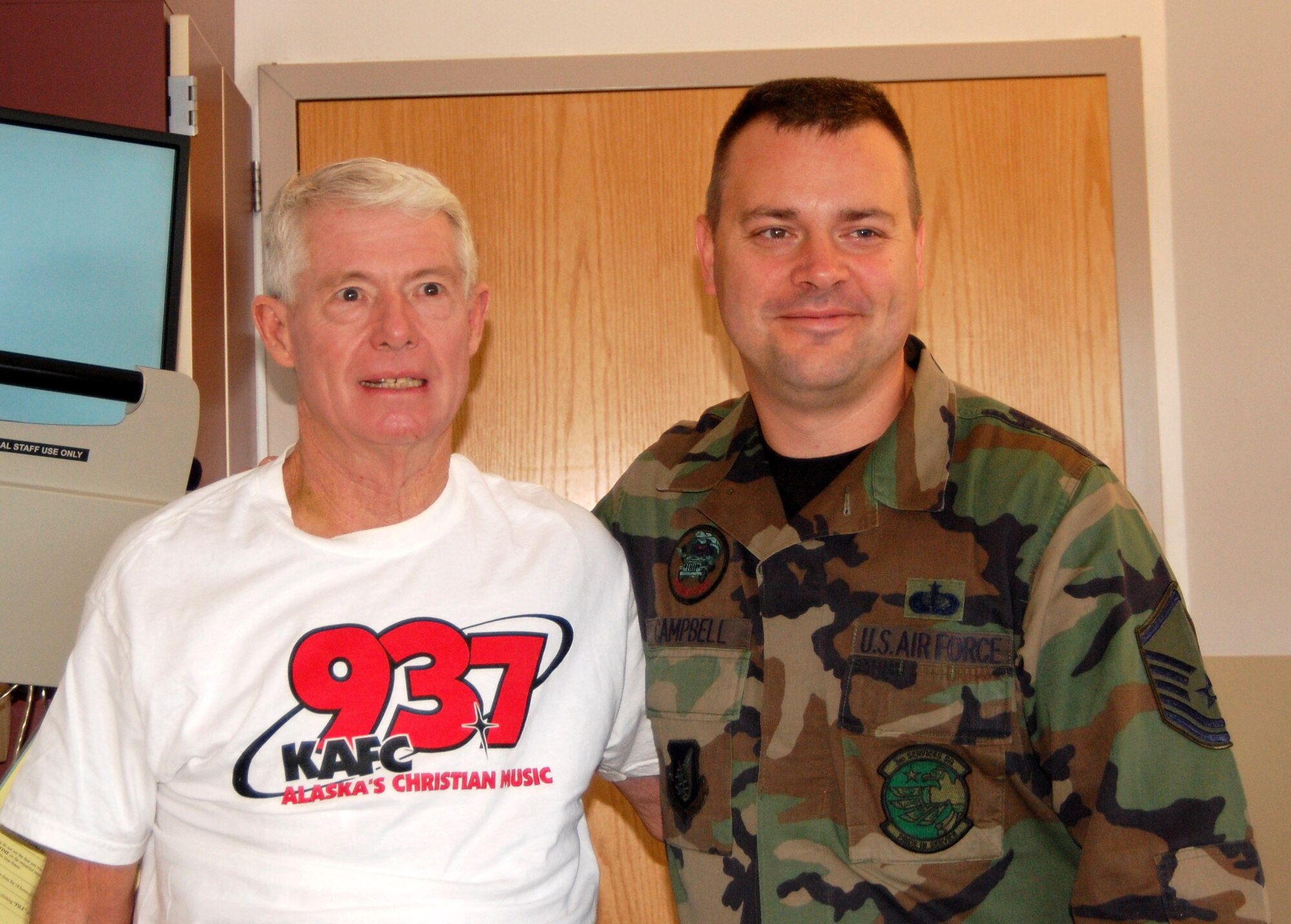 David Ira shares a moment with Master Sgt. Robert Campbell, who saved Mr. Ira's life with CPR. Sergeant Campbell is a member of the 3rd Services Squadron at Elmendorf Air Force Base, Alaska. (Courtesy photo)