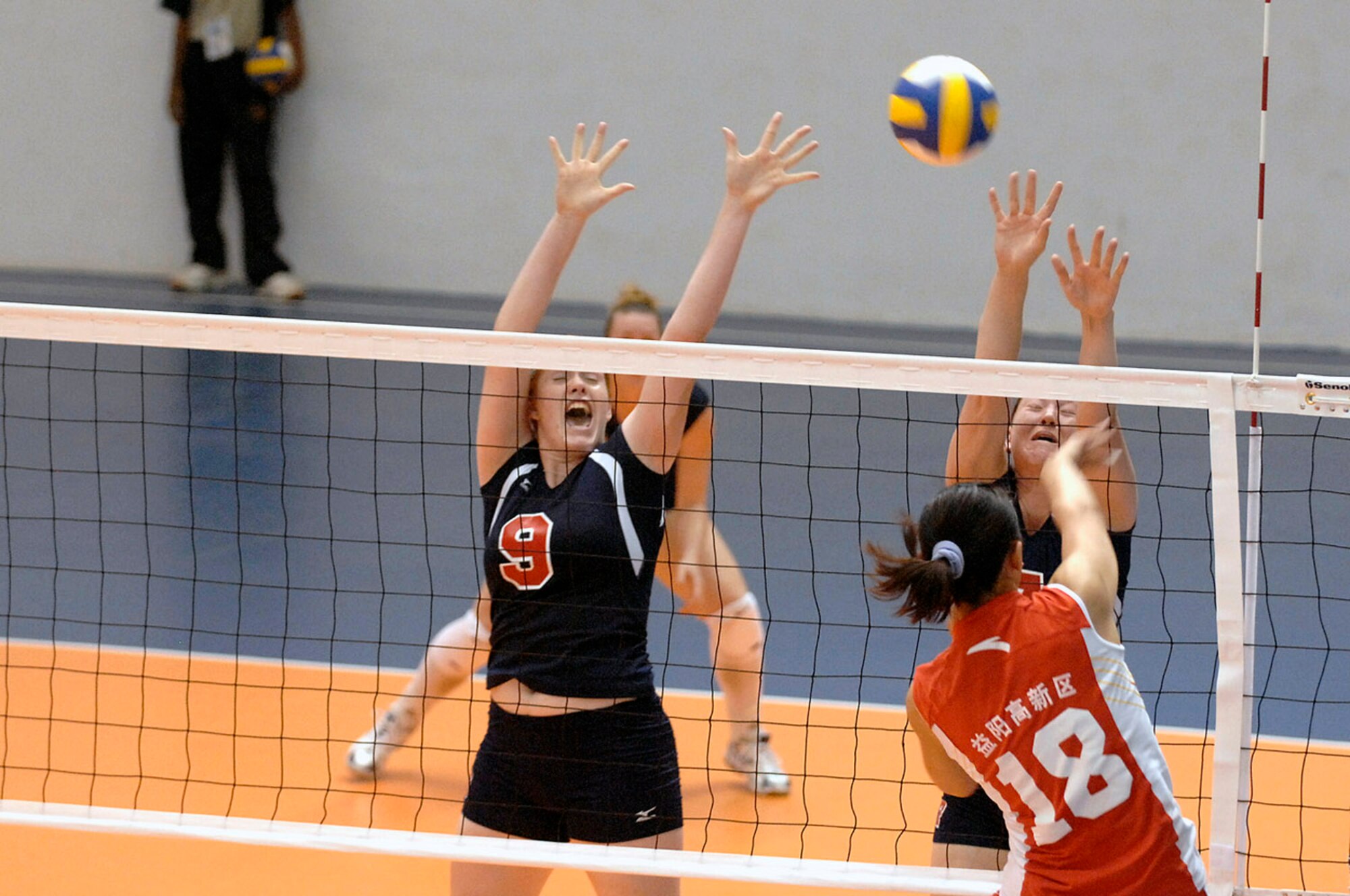 Spc. Sarah Lusk and Ens. Ashley Kins try to block a shot by 2nd Lt. Liu Xiaojing of China during the U.S. women's first volleyball game at the Military World Games in Hyderabad, India.  The U.S. women fell to the Chinese team in three games, 25-15, 25-11, 25-7.  The Conseil Internationale du Sport Militaire's Military World Games event is the largest international military Olympic-style event in the world.  In this year's fourth edition of the Games, 103 countries and more than 5,000 athletes are competing Oct. 14 to 21 in boxing, diving, soccer, handball, judo, military pentathlon, parachuting, sailing, shooting, swimming, volleyball and track and field. The purpose of the Military World Games is to promote "friendship through sport."  (U.S. Navy photo/Petty Officer 2nd Class Jennifer A. Villalovos)