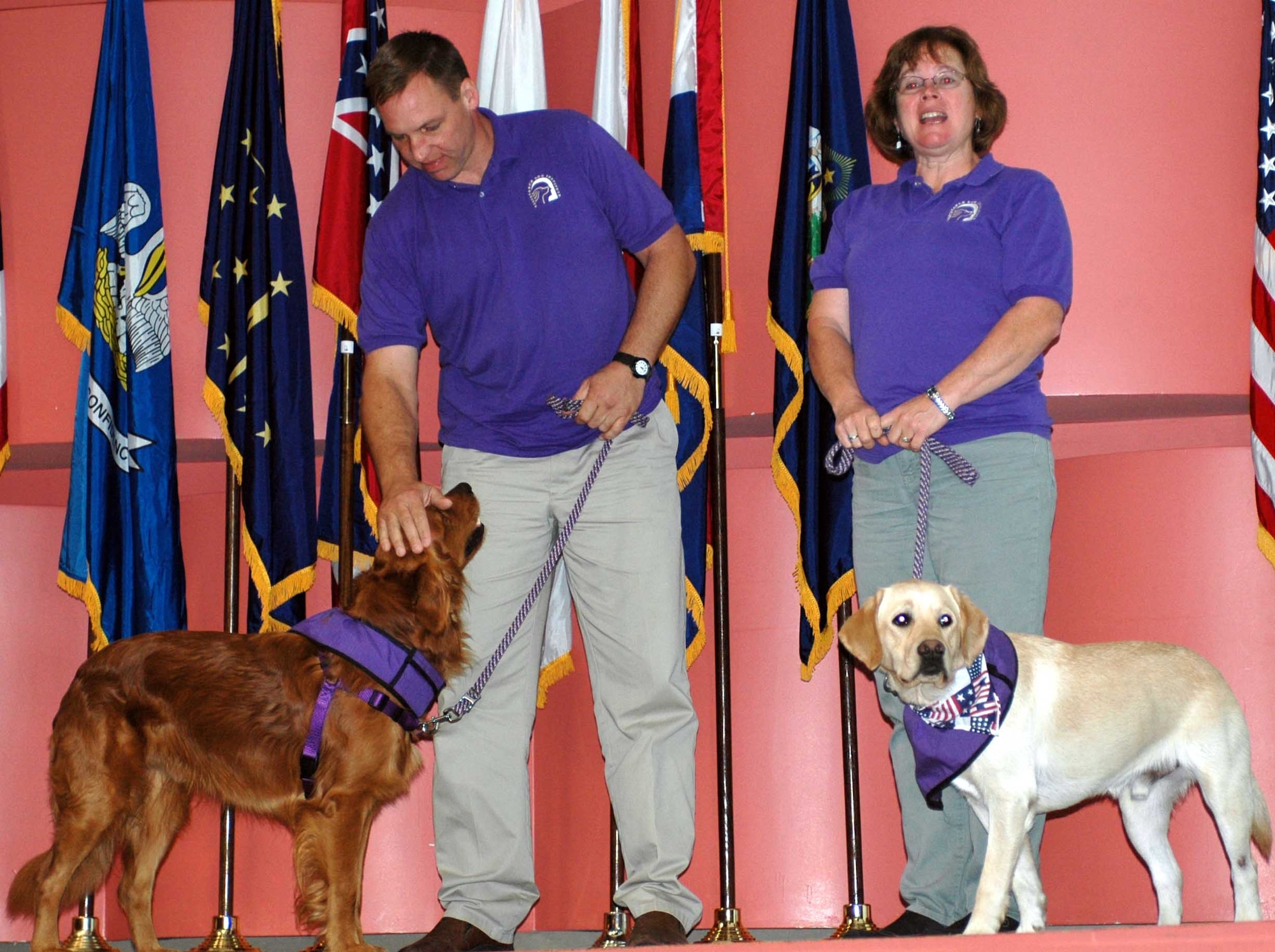 Representatives from the Assistance Dog Institute present information about their charity during the 2007 Combined Federal Campaign kickoff event Oct. 15 at the David Grant USAF Medical Center’s auditorium. The CFC collects contributions from federal employees, including servicemembers, on behalf of different charitable organizations. (U.S. Air Force photo/Airman 1st Class Kristen Rohrer) 