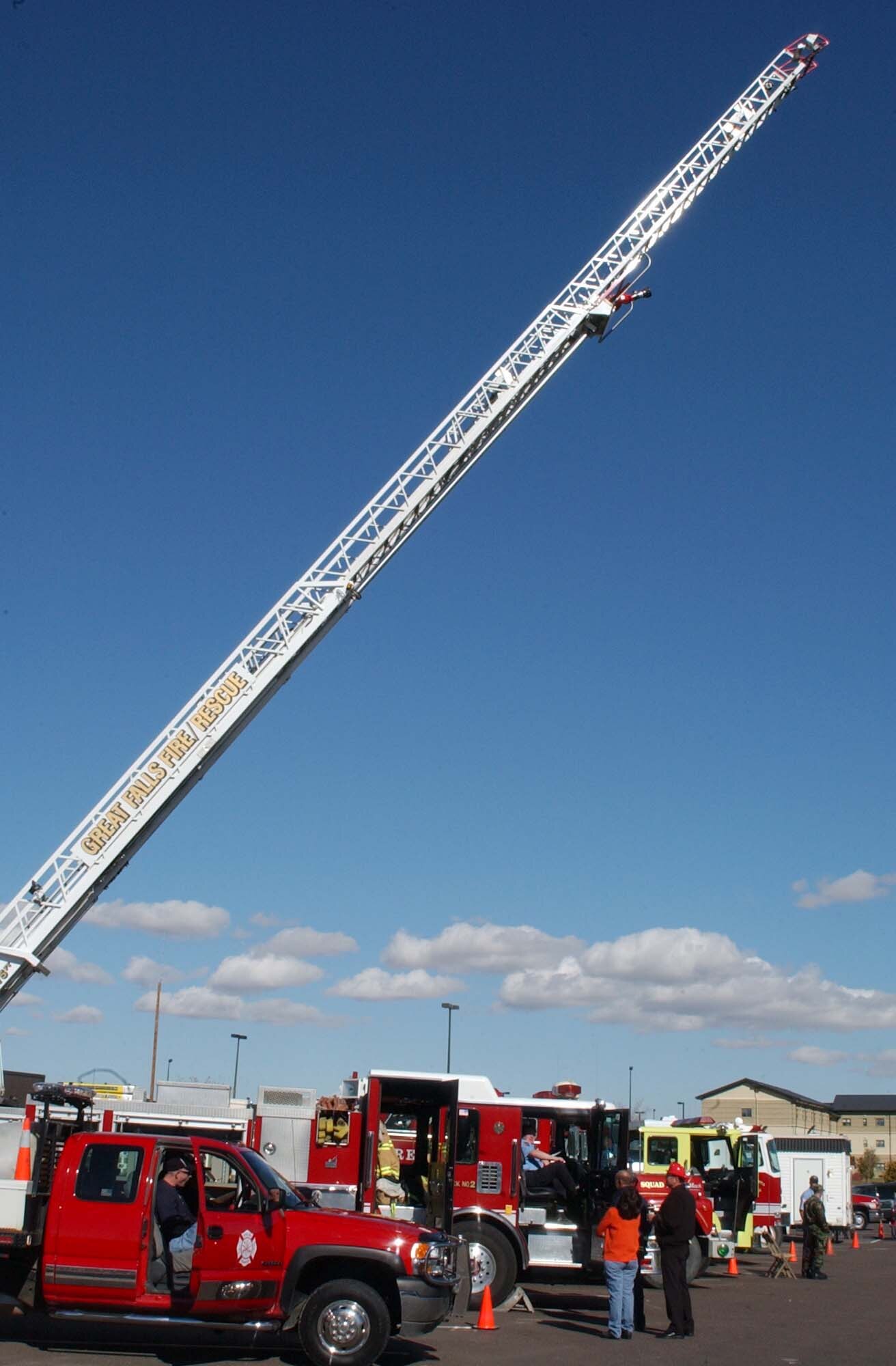 Local area firefighters and the Malmstrom fire department line up in front of the base exchange at Malmstrom Oct. 13 prior to a parade that wrapped up fire prevention week. Many activities were held throughout the week to include tours of the fire department, along with visits to the base library and Child Development Center. (U.S. Air Force photo/ Airman 1st Class Dillon White)