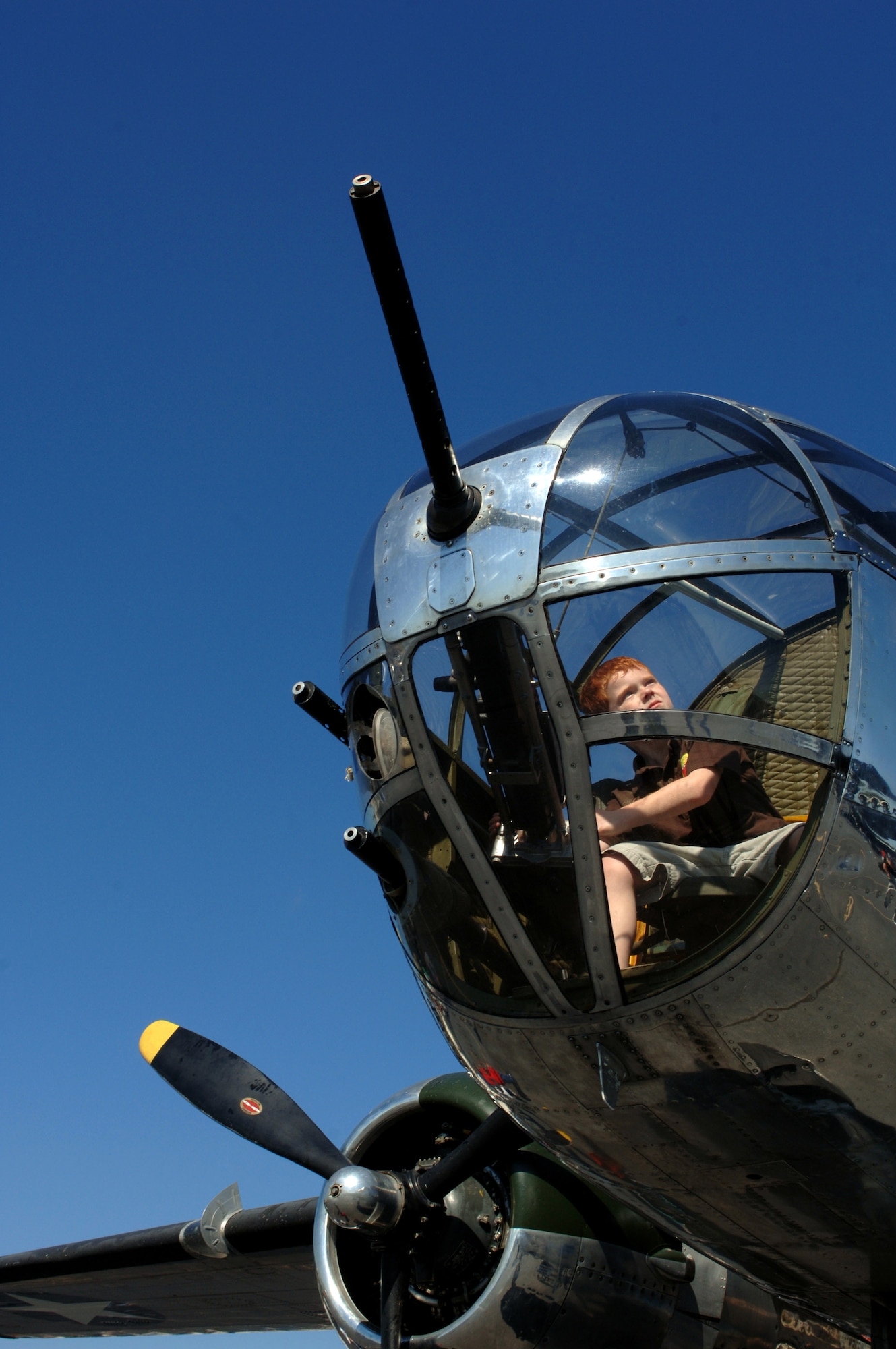 7-year-old Michael Webb of Mansfield, Ga., looks for enemy targets while sitting inside the gunner's seat of a B-25J Mitchell on display during the Great Georgia Air Show culminating Air Force Week Atlanta Oct. 13 at Peachtree City, Ga. Atlanta is one of six cities throughout the country chosen to host an Air Force Week. The theme for the year is "Heritage to Horizons," celebrating the 60th anniversary of the Air Force, its history and the future of the world's greatest force in air and space. (U.S. Air Force photo/Staff Sgt. Bennie J. Davis III)
