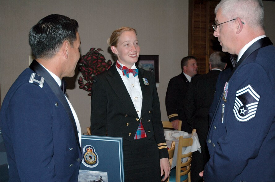 Navy Lt. Petra Smith, Snowbirds public affairs officer, center, chats with Col. Steve Asher, 341st Security Forces Group commander, left, and Senior Master Sgt. Jeffrey Wills, 341st Maintenance Operations Squadron training flight superintendent, right, Oct. 12 at the Snowbirds aerial demonstration team’s end-of-season celebration in Moose Jaw, Saskatchewan. The Snowbirds wanted to thank Malmstrom for their efforts in May after one of their pilots died during a practice flight on base, and invited 11 Airmen up to join in the season finale's festivities. (U.S. Air Force photo/Senior Airman Eydie Sakura).