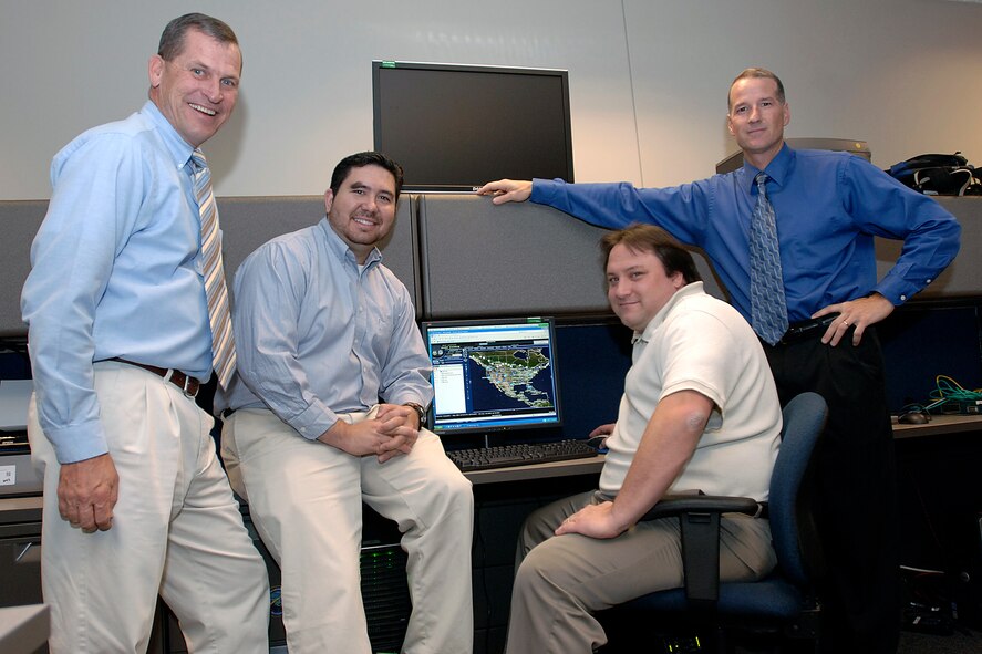 The team that developed a system that allows users at North American Aerospace Command and U.S. Northern Command to quickly and easily access detailed geospatial data has been selected to receive the 2007 United States Geospatial Foundation's achievement award in the military category. Members of the Space and Naval Warfare Center C4I Engineering Support Team are (from left) Gary Koch, Chris Mayfield, Dave Gokey and Dave McKinley.  (U.S. Air Force photo/Army Sgt. 1st Class Gail Braymen) 