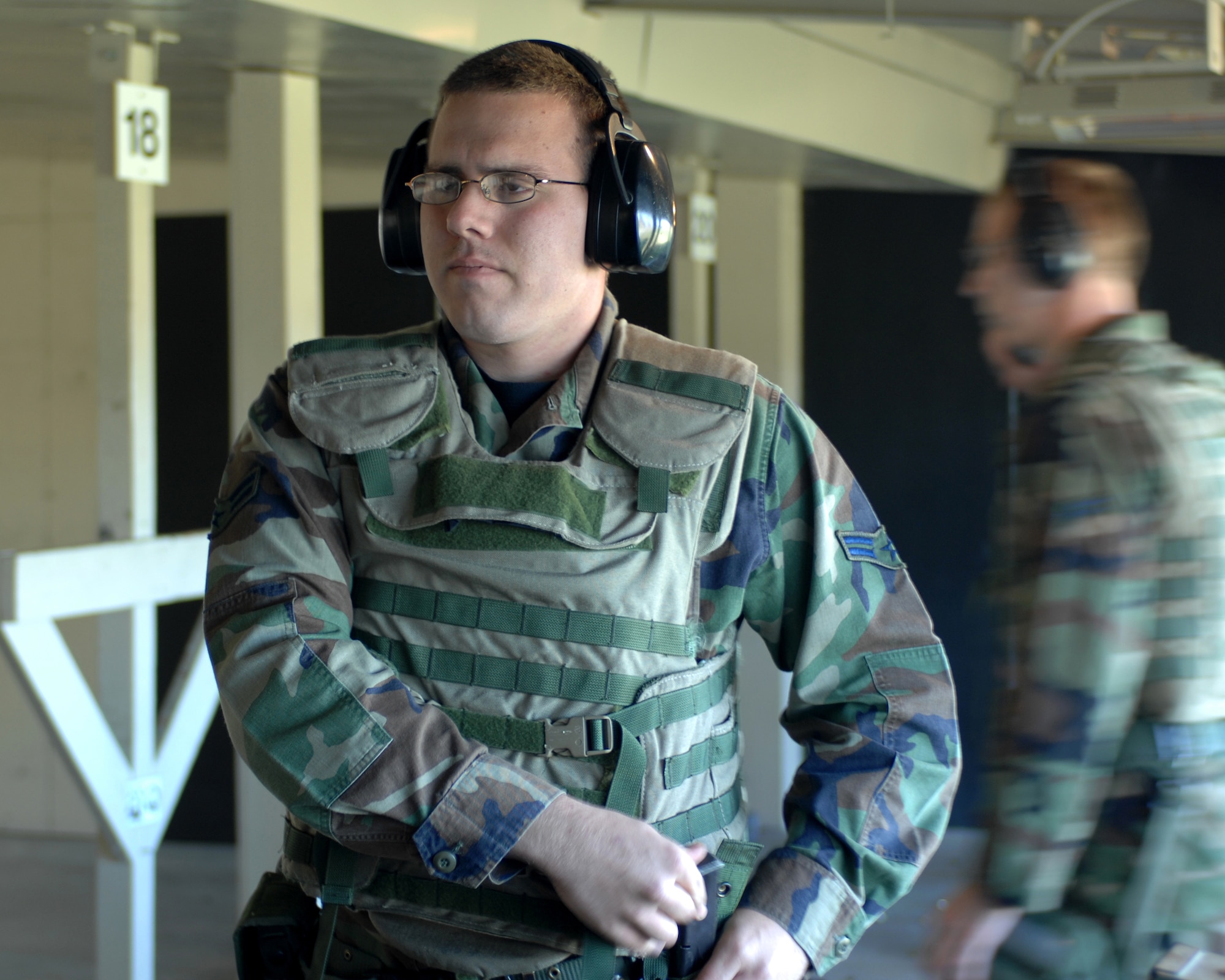 WHITEMAN AIR FORCE BASE, Mo. - Airman 1st Class Robert Ragsdale, 509th Security Forces Squadron, readies a magazine into his web belt prior to firing for M9 pistol qualification Oct. 11. (U.S. Air Force photo/Staff Sgt. Charles D. Larkin Sr.)         