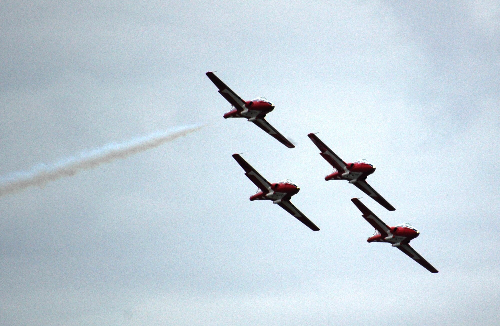 The Canadian Forces Snowbirds aerial demonstration team performs a fly-by in honor of their lost teammate, Capt. Shawn McCaughey, Snowbirds 2 pilot, at their end-of-season show in front of special guests, family and friends Oct. 12 in Moose Jaw, Saskatchewan. The Snowbirds wanted to thank Malmstrom for their efforts in May after Captain McCaughey died during a practice flight on Malmstrom Air Force Base, Mont., and invited 11 Airmen up for their final show of the year. (U.S. Air Force photo/Senior Airman Eydie Sakura).