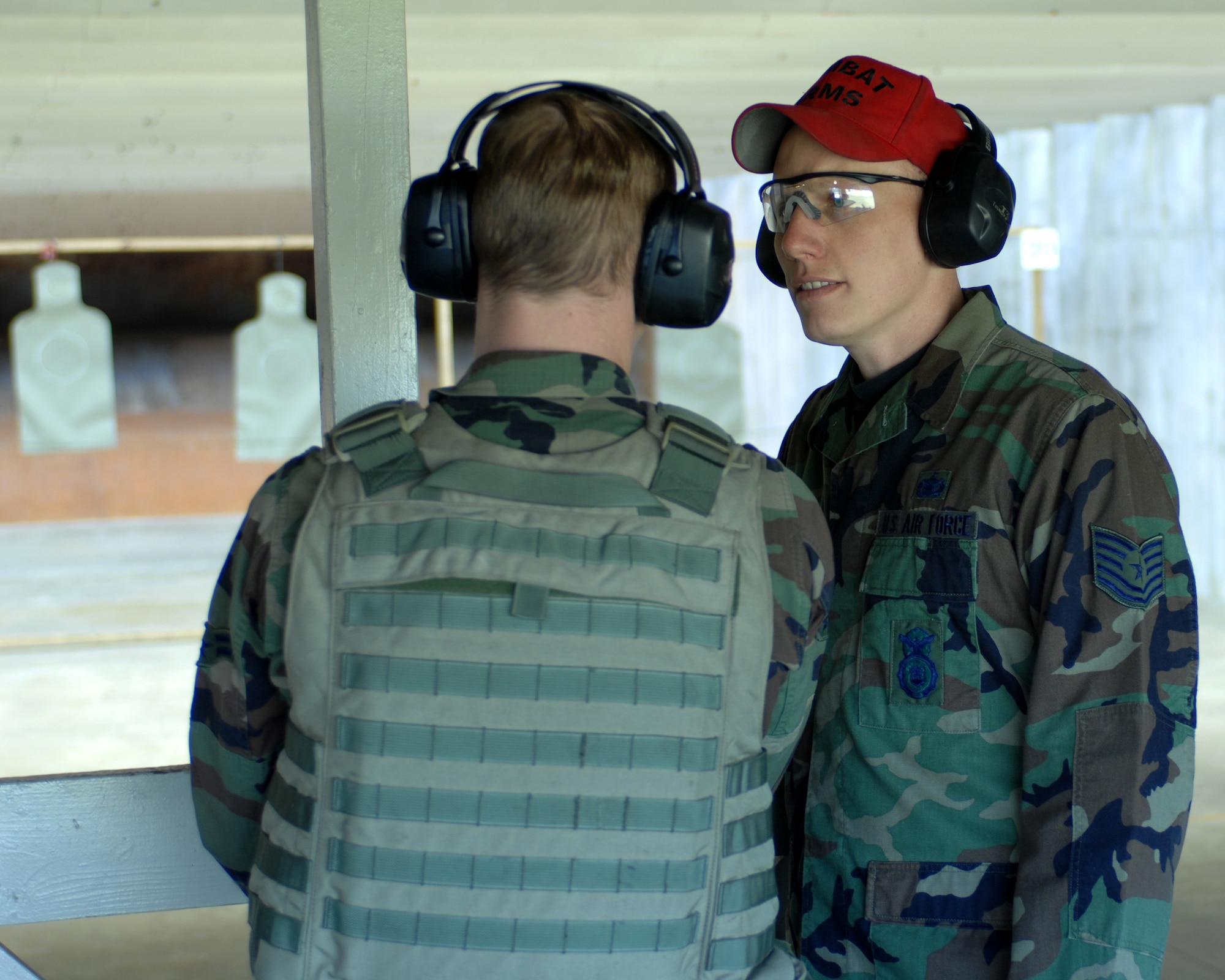 WHITEMAN AIR FORCE BASE, Mo. - Combat Arms Instructor Tech. Sgt. William Duft, 509th Security Forces Squadron, explains to Airman 1st Class Rusty Rushing, 509 SFS, proper de-cocking procedures of the M9 pistol while on the firing range Oct. 11. (U.S. Air Force photo/Staff Sgt. Charles D. Larkin Sr.)