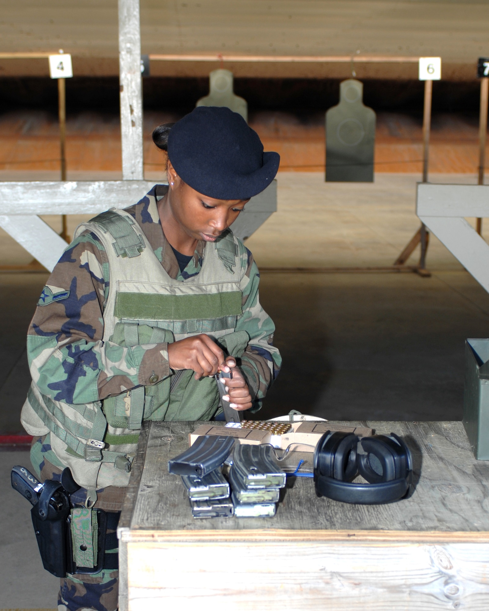 WHITEMAN AIR FORCE BASE, Mo. - Airman Deshaina Dawson, Security Forces Squadron, loads ammunition into M9 magazines as she prepares to qualify with the pistol Oct. 11. (U.S. Air Force photo/Staff Sgt. Charles D. Larkin Sr.)