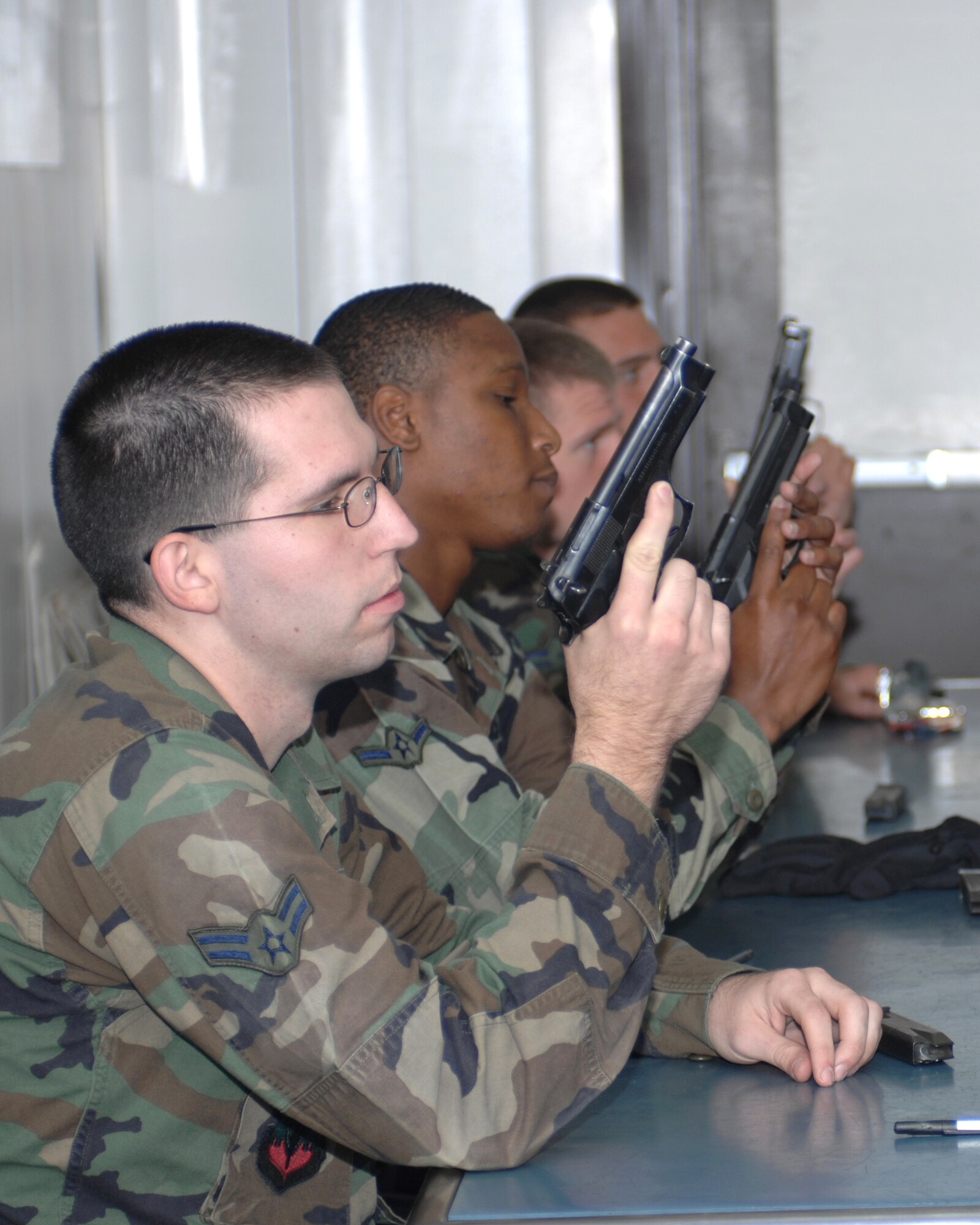WHITEMAN AIR FORCE BASE, Mo. - Members of the 509th Security Forces Squadron inspect the sights of the M9 pistol during disassemble and inspection phase of the classroom instruction Oct. 11. (U.S. Air Force photo/Staff Sgt. Charles D. Larkin Sr.)     