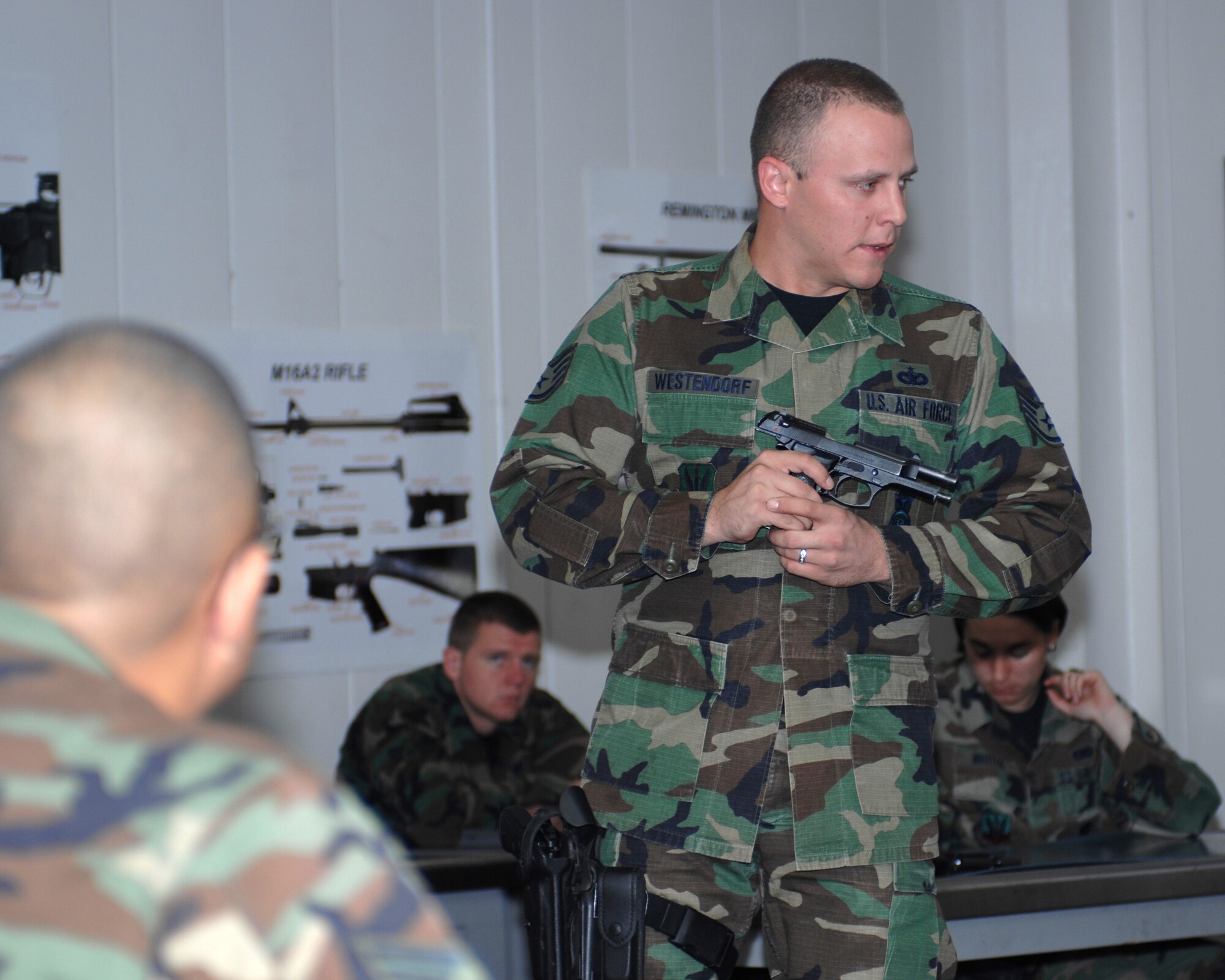 WHITEMAN AIR FORCE BASE, Mo. - Combat Arms Instructor Staff Sgt. Kyle Westendorf, 509th Security Forces Squadron, demonstrates how to properly clear the M9 pistol to members of the 509th SFS Oct. 11. (U.S. Air Force photo/Staff Sgt. Charles D. Larkin Sr.)