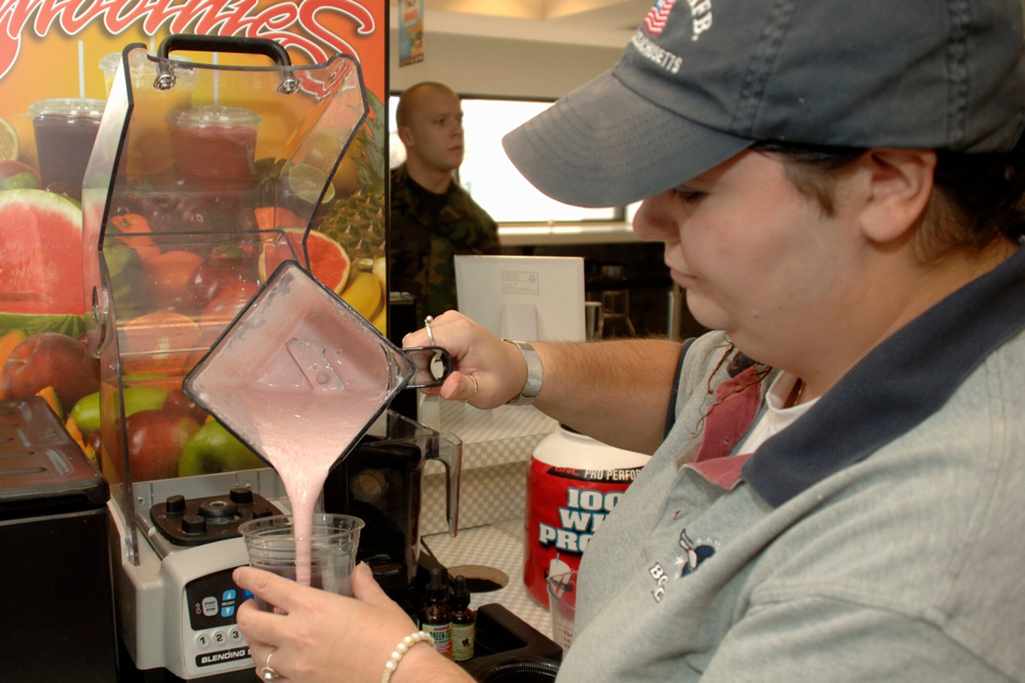Kerry-Anne Aghoian, 66th Services Squadron, pours a strawberry smoothie for a 13th Frame Diner customer Oct.15.  Smoothies and other nutritious selections have recently been added to the diner’s menu for health-conscious customers to enjoy. (U.S. Air Force photo by Jan Abate)
