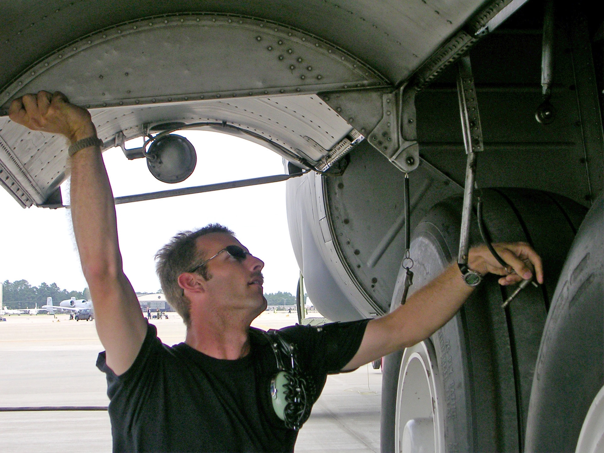 Staff Sgt. Alan Hunter works to secure the landing gear doors on a 440th Airlift Wing C-130H Hercules on the Blue Ramp at Pope Air Force Base, N.C., after receiving a high-wind warning. Sergeant Hunter is a former member of the 43rd Airlift Wing, the Regular Air Force?s host unit at Pope AFB. He is the second active-duty Airman to join the 440th Maintenance Group. He was stationed at Pope AFB for six years before joining the Air Force Reserve. (U.S. Air Force photo)