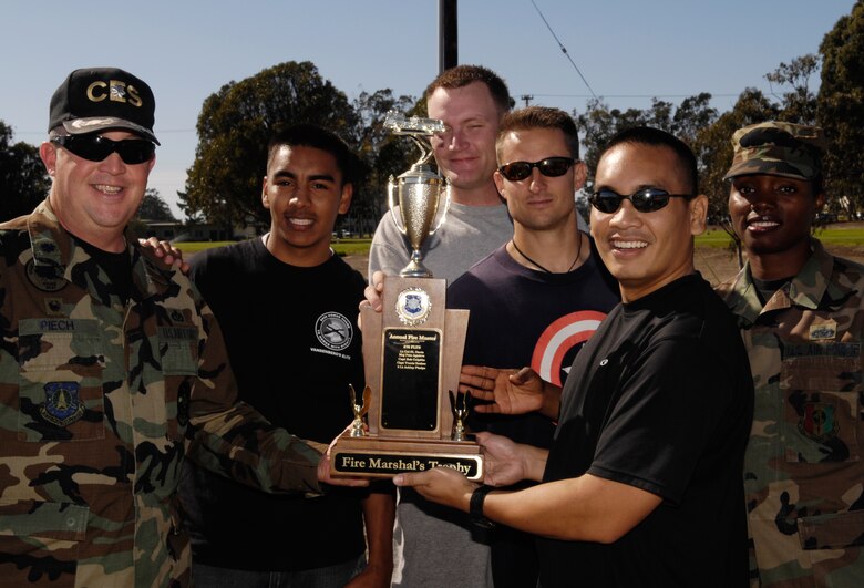 VANDENBERG AIR FORCE BASE, Calif. -- Lt. Col David Piech, 30th Civil Engineers Squadron commander, presents members of the 381st Training Support Squadron for winning the second annual fire muster competition Oct. 11. The fire muster competition is held every year to demonstrate what a fire fighter has to face physically and gives squadrons a chance to compete against one another.  (U.S. Air Force photo/Airman 1st Class Christian Thomas) 