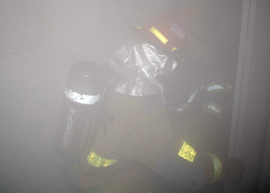 Competitors work their way through a smoke-filled house Oct. 9 during the annual Commander's Smokehouse Challenge. The event is one of many put on by the Sheppard Fire Department during Fire Prevention Week. (U.S. Air Force photo/Lou Anne Sledge)