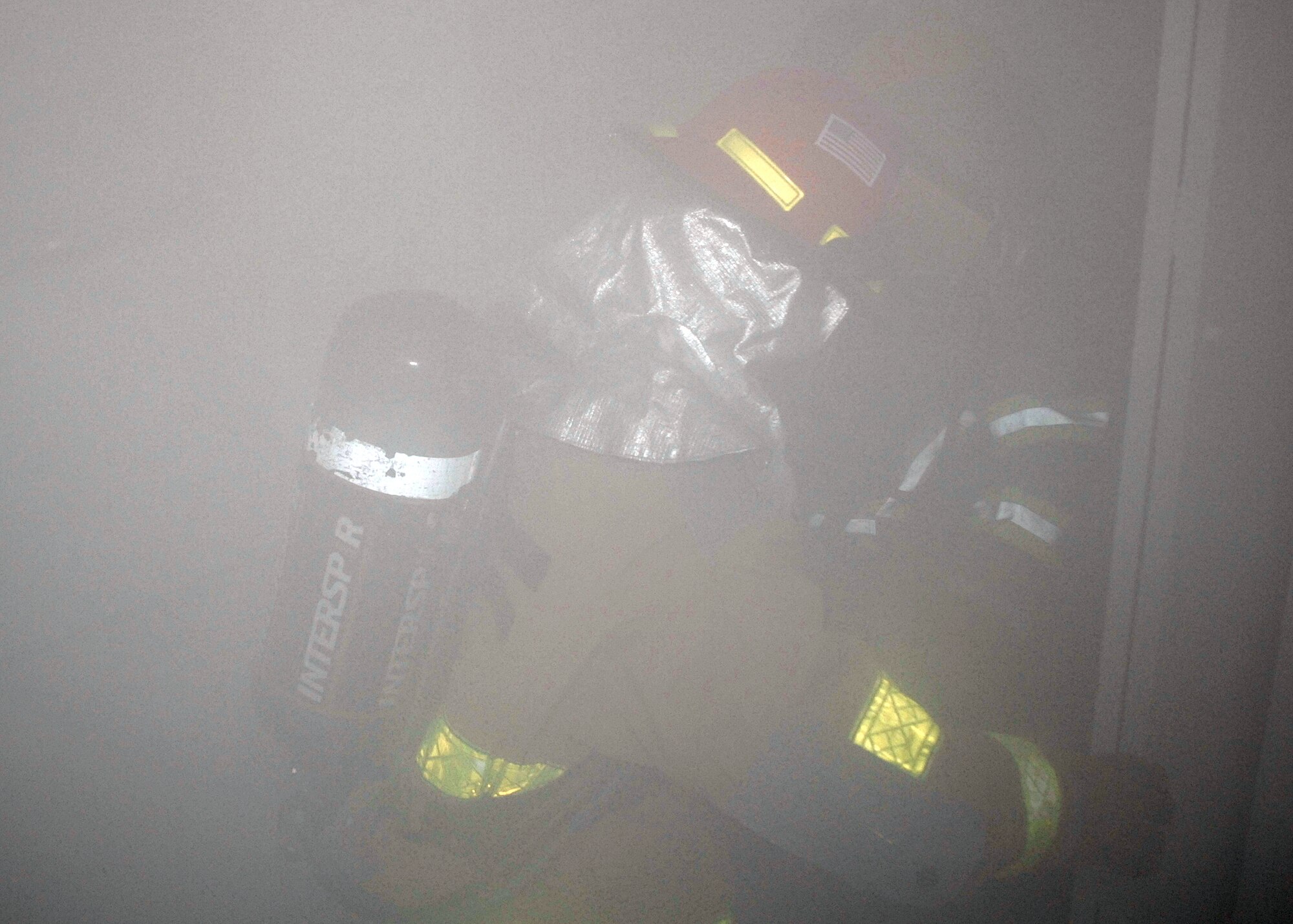 Competitors work their way through a smoke-filled house Oct. 9 during the annual Commander's Smokehouse Challenge. The event is one of many put on by the Sheppard Fire Department during Fire Prevention Week. (U.S. Air Force photo/Lou Anne Sledge)