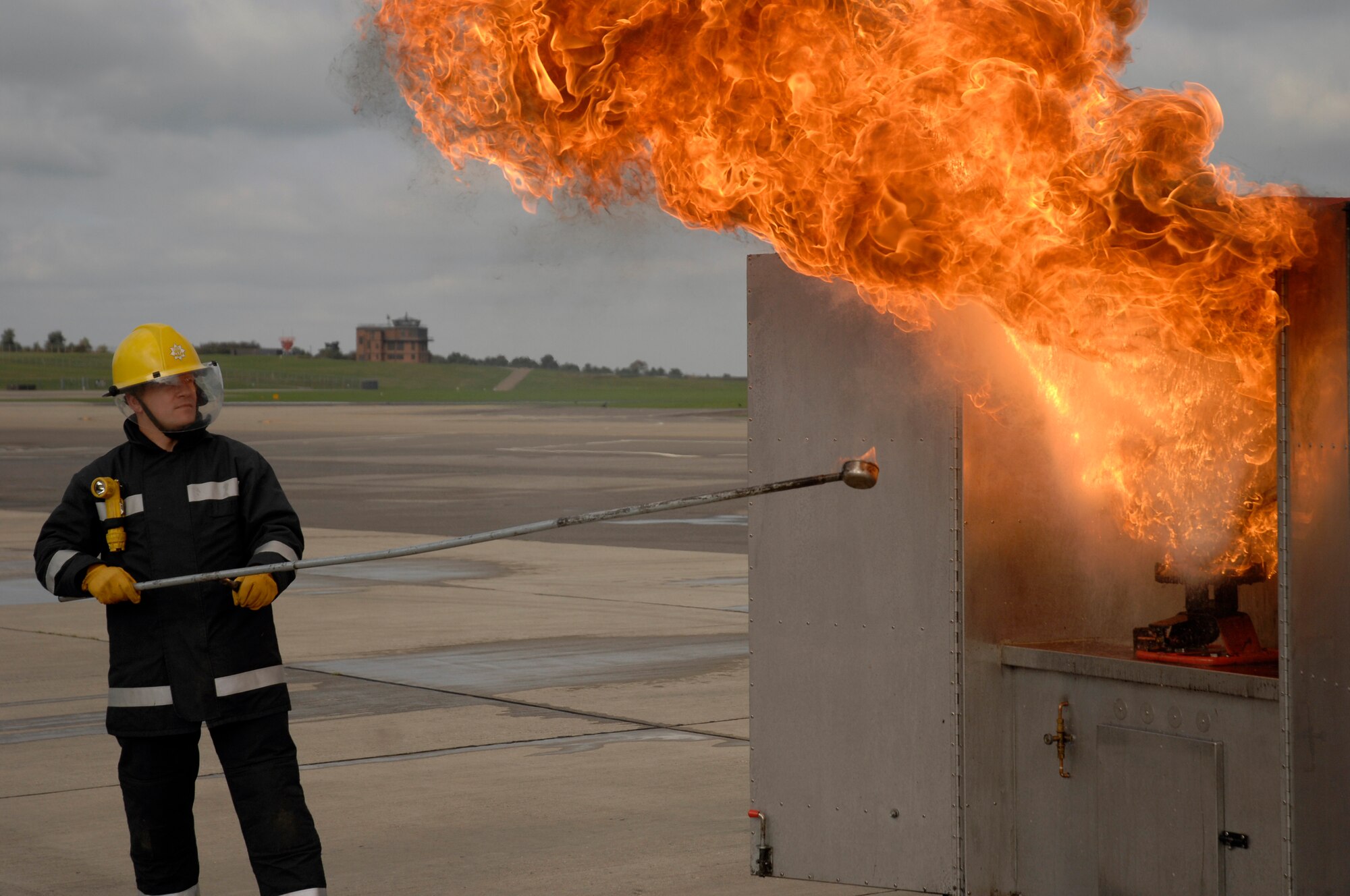 David King, a fire fighter at the Brandon Suffolk Fire and Rescue Service station, conducts a chip-pan demonstration Oct. 13 at the RAF Lakenheath fire department. The demo illustrates the effects of using water to extinguish a grease fire. The demonstration was a part of the base's Fire Prevention Week observance. (U.S. Air Force photo by Airman 1st Class Erika Brooke)