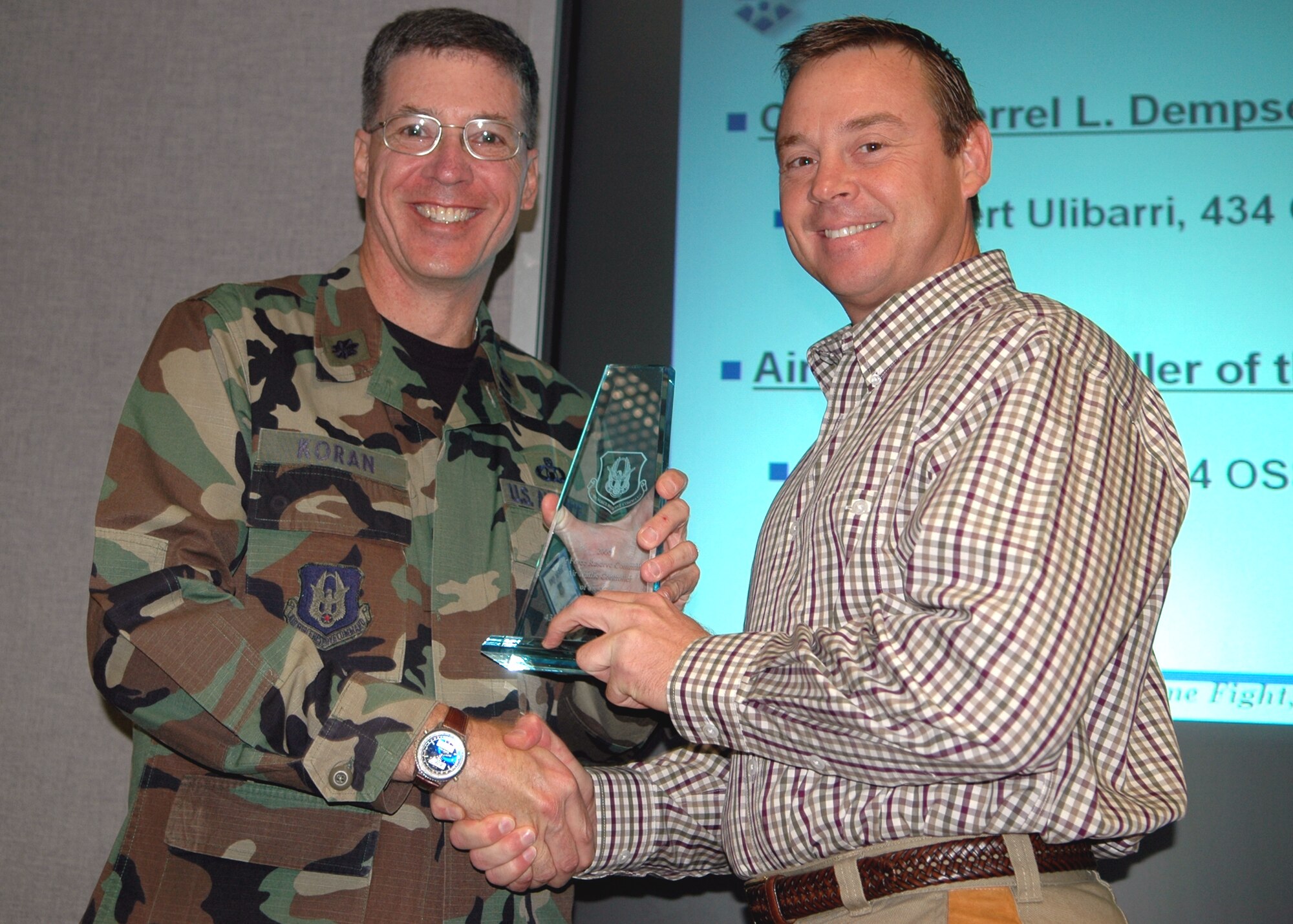 GRISSOM AIR RESERVE BASE, Ind., -- Lt. Col. Kenton Koran, left, Air Force Reserve Command air traffic control office, presents Mr. Kevin Ware, air traffic controller, with the Air Traffic Control Specialist of the Year award. (U.S. Air Force photo/ Senior Airman Carl Berry)