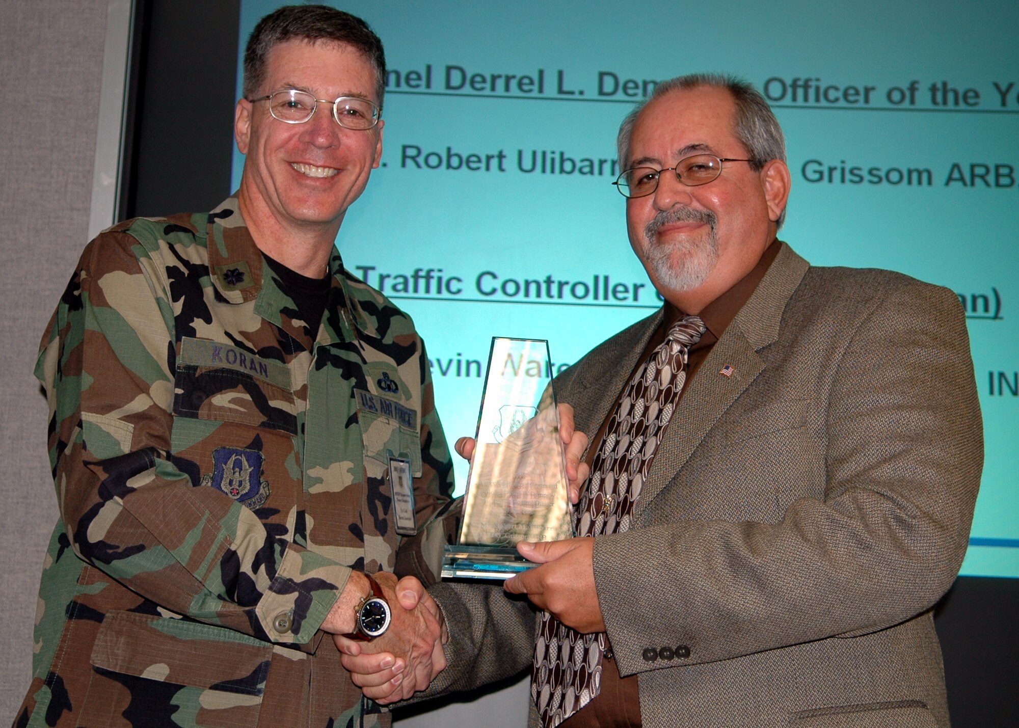 GRISSOM AIR RESERVE BASE, Ind., -- Lt. Col Kenton Koran, left, Air Force Reserve Center air traffic control office, presents Mr. Robert Ulibarri, airfield operations manager, with the Airfield Operations Manager of the Year award. (U.S. Air Force photo/ Senior Airman Carl Berry)
