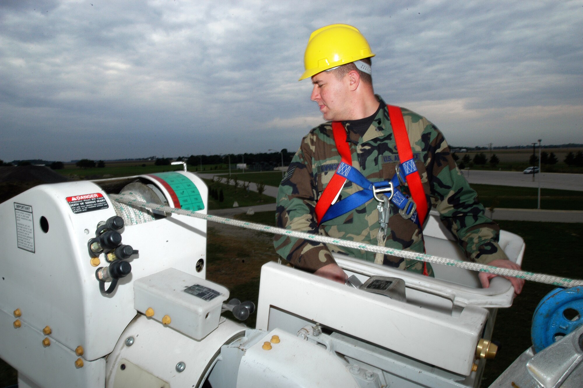 GRISSOM AIR RESERVE BASE, Ind. -- Staff Sgt. Chris Kopinski, 434th Civil Engineers Squadron electrician, lowers the boom on a "cherry picker" after assisting in electrical pole training. Airmen from the 434th CES were practicing climbing and maintenance on electrical poles during a recent unit training assembly. (U.S. Air Force photo\Staff Sgt. Mark R. W. Orders-Woempner)