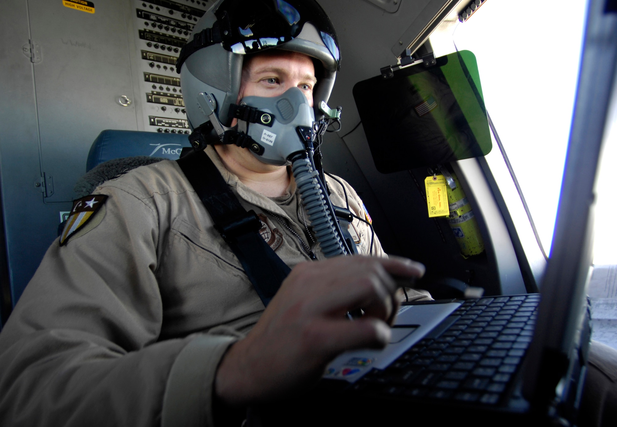 Capt. Mathew Oliver uses the Precision Air Drop System to calculate the precise airdrop release point Oct. 11 over Afghanistan. The computer gets some of its information from a dropsond, released over the drop zone, that sends information such as altitude and wind speed back to the computer. A total of 62 cargo bundles were dropped from two C-17s in two passes. This was the first time a combat cargo drop of this magnitude has taken place from two C-17s in formation over one drop zone. The planes and crews are part of the 817th Expeditionary Airlift Squadron, Manas, Kyrgyzstan. (U.S. Air Force photo/Staff Sgt. Brian Ferguson)
