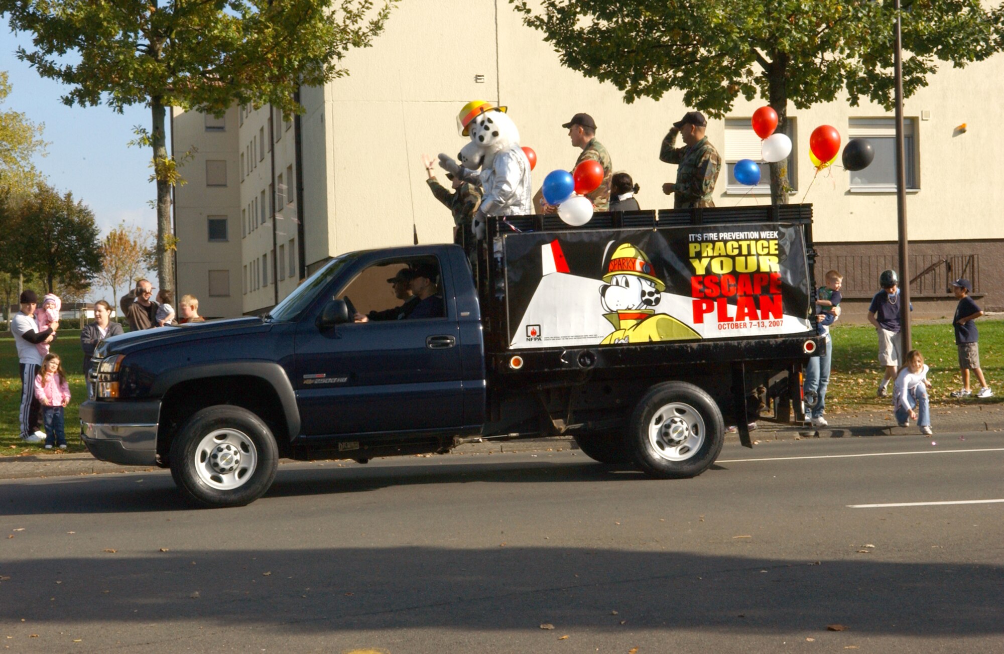 SPANGDAHLEM AIR BASE, Germany -- Sparky the fire dog waves to children during the fire prevention week parade at Bitburg Annex Oct. 13. (U.S. Air Force photo/Airman 1st Class Allen Pollard)