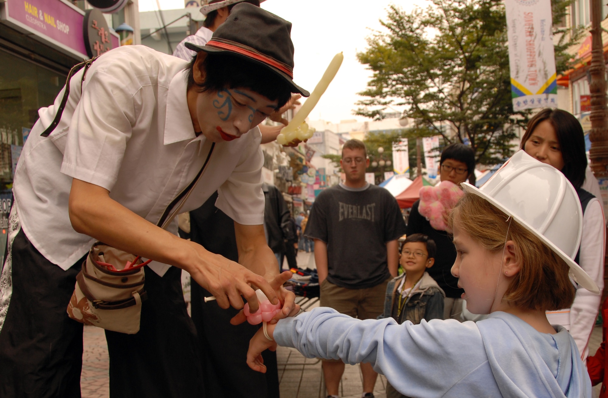 OSAN AIR BASE, Republic of Korea -- Sarah Wheeler, the 6-year-old daughter of 1Lt Richard Wheeler, 7AF, receives a balloon bracelet from a street performer during the Korean/American Friendship Festival on Oct. 15, 2007 (U.S. Air Force photo by Staff Sgt. Ronnie Hill) (Released)