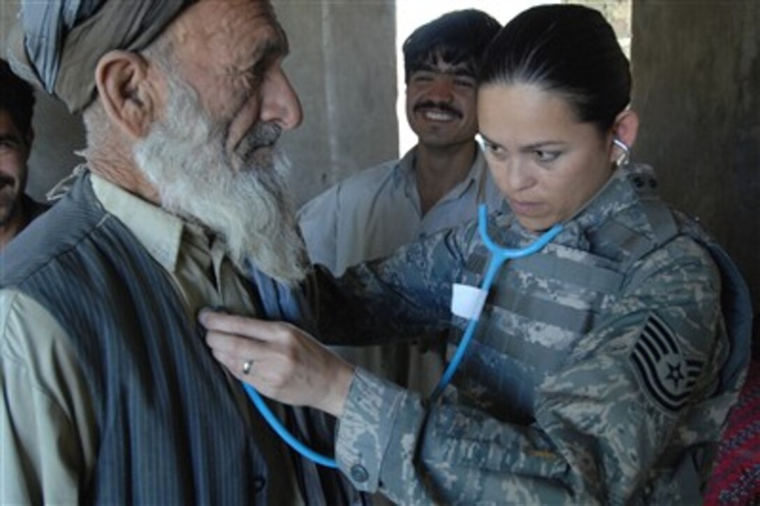 U.S. Air Force Tech. Sgt. Joy Flumerfelt provides medical care to an elderly man in a small village near Bagram Airfield, Iraq, on Oct. 4, 2007.  Flumerfelt is a medical technician with the 455th Air Expeditionary Wing.  