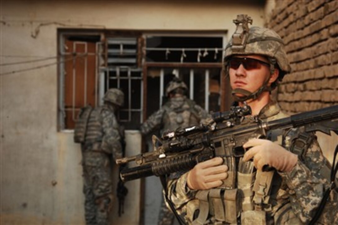 U.S. Army Spc. Anthony Register provides security for fellow soldiers at an unoccupied house in the East Rashid district of Baghdad, Iraq, on Oct. 9, 2007.  Register is assigned to the 3rd Platoon, Hotel Company, 3rd Squadron, 2nd Stryker Cavalry Regiment.  