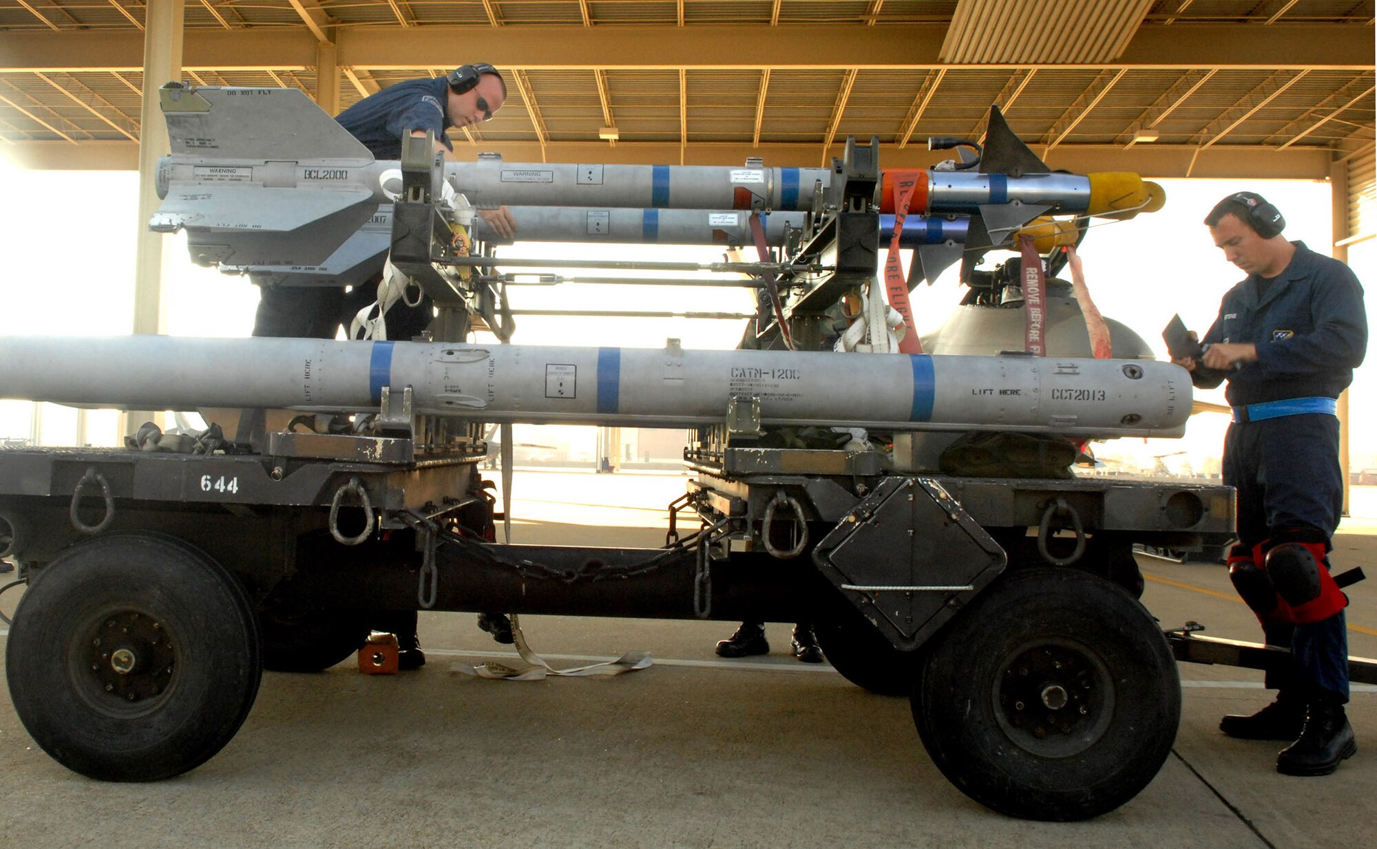 Tech Sgts. Thomas Harper and David Martens perform an AIM-120 missile wing and fin preparation, which is done to ensure the wings and fins are undamaged prior to installation on the missile. This particular crew is from the Air National Guard's 192nd Fighter Wing, working out of the 94th Aircraft Maintenance Unit. The 27th and 71st AMUs  will perform similar competitions, and earn points based on the fastest and safest crew. After each crew loads their weapons, scores are tallied and a winning crew will be announced. These competitions are performed on a quarterly basis and these winners will compete for the Load Crew of the Year. (U.S. Air Force photo/Senior Airman Cecil C. McCloud)