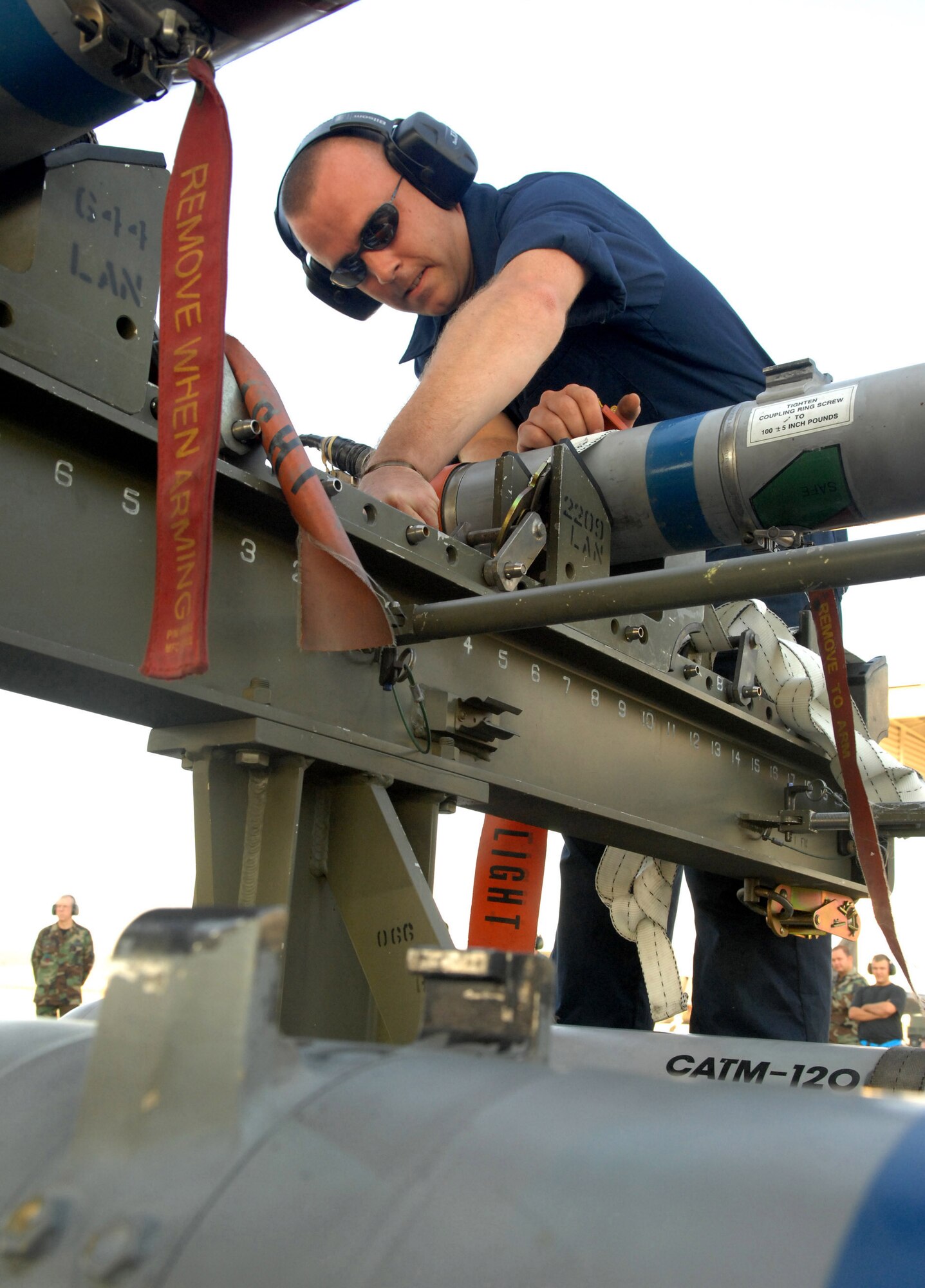 Tech. Sgt. Thomas Harper performs an AIM-9 missile munitions preparation for the weapons load crew competition at the 94th Fighter Squadron Oct. 17. Sergeant Harper is part of the Air Nationa Guard's 192nd Fighter Wing crew, which worked out of the 94th Aircraft Maintenance Unit. During this competition, the crew loaded two AIM-9 missiles and two AIM-120 missiles on the F-22A. The 27th and 71st AMUs will perform a similar competitions and earn points based on the fastest and safest crew. After each crew competes, scores are tallied and a winning crew will be announced. These competitions are performed quarterly, and quarterly winners will compete for the Load Crew of the Year. (U.S. Air Force photo/Senior Airman Cecil C. McCloud)
