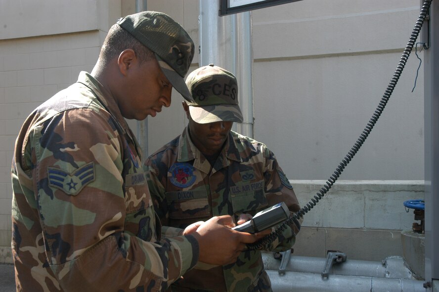KUNSAN AIR BASE, South Korea -- Senior Airman Aldre Drummonds (left), 8th Civil Engineer HVAC journeyman, and Staff Sgt. Swain Dixon, 8th CES HVAC craftsman, inspect a chiller in preparation for seasonal shutdown. (U.S. Air Force photo/Staff Sgt. Alice Moore)                                                                                                                                                                                                  