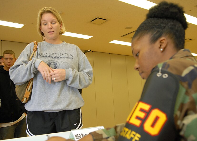 YOKOTA AIR BASE, Japan - Yokota Non-Combantant Evacuation Operations (NEO) personnel sign in people at the Taiyo Recreation Center during a NEO exercise on October 17.  The exercise is designed to test the ability of the base to receive and send non-combatants home if real-world disaster or wartime effort breaks out in the Pacific theater. (U.S. Air Force photo by Senior Airmen John Albea)