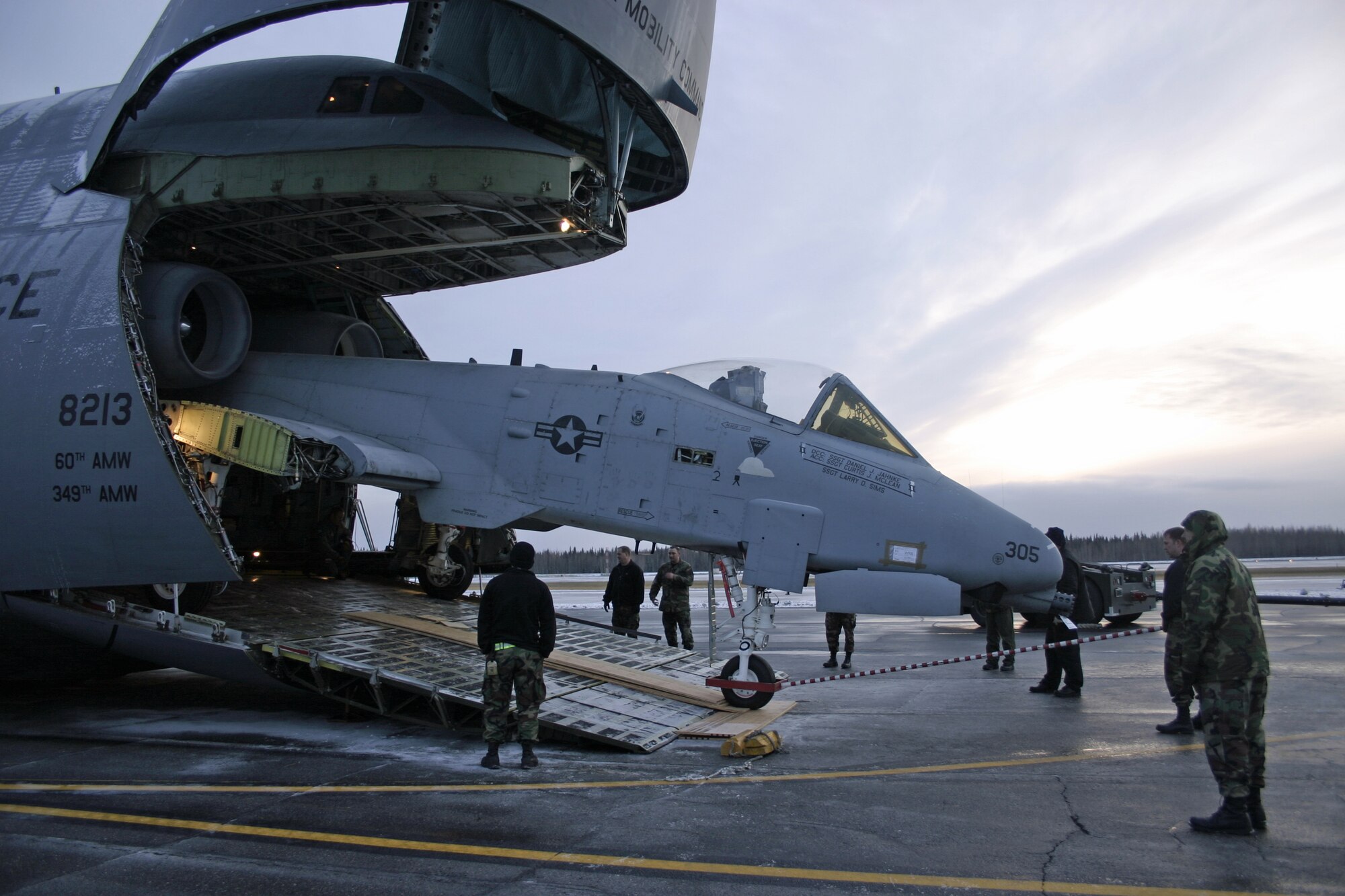 EIELSON AIR FORCE BASE, Alaska--The team working on the inactive A-10, winches the aircraft into the C-5 for transport to the Robbins AFB, Ga. Museum of Aviation Flight and Technology Center Oct. 6 on the flightline. The aircraft was disassembled into six different sections in three days. This was the first time that an A-10A has been dismantled at field level. (U.S. Air Force photo by Staff Sgt. Brian Hibbert)