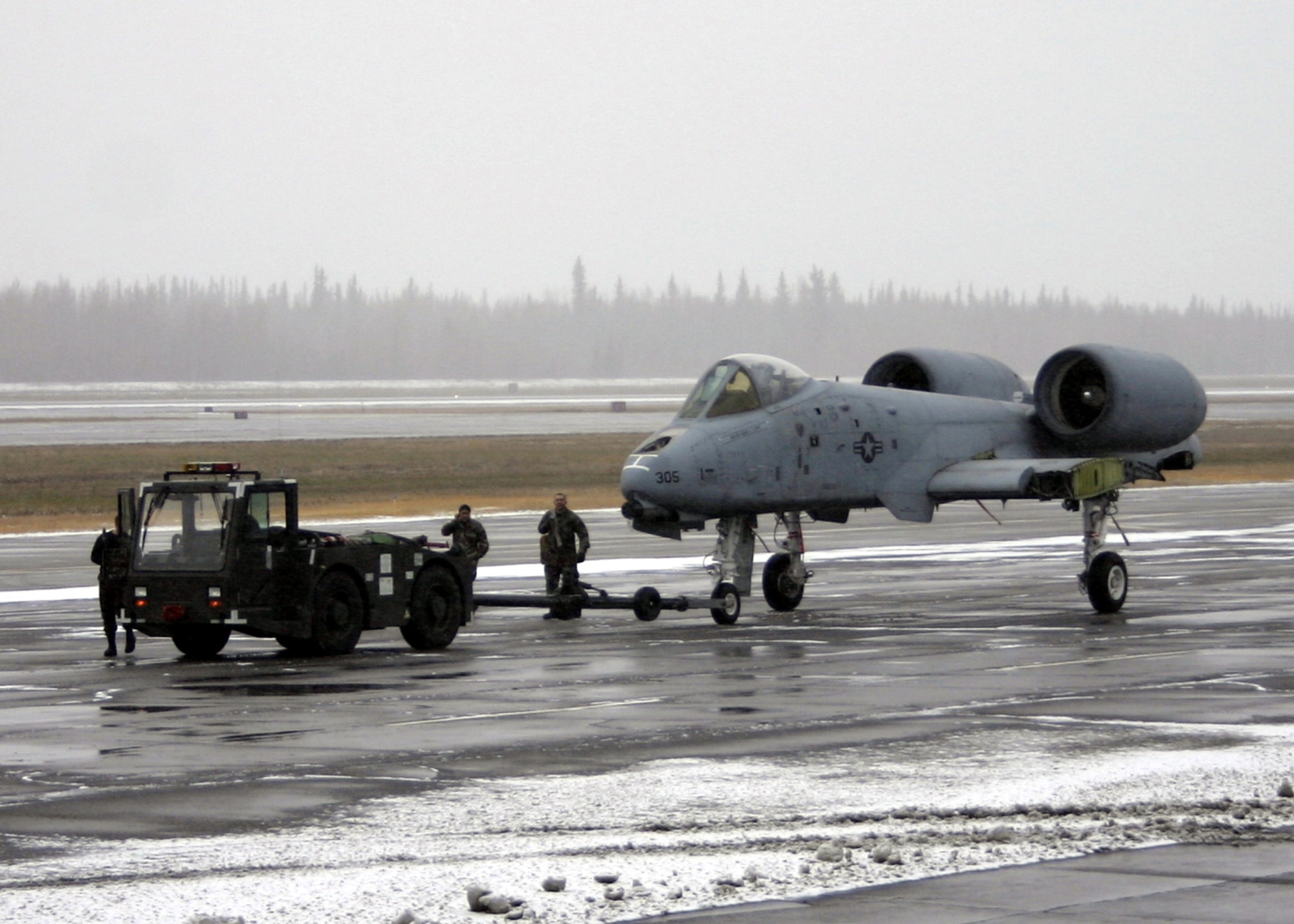 EIELSON AIR FORCE BASE, Alaska--The inactive A-10A Arctic Hawg is towed toward the C-5 Galaxy for transport to the Robins AFB, Ga. Museum of Aviation Flight and Technology Center Oct. 6 on the flightline. The A-10 is the last of Eielson's Arctic Hawgs to leave base, being inactivated in 1996 due to the Air Force's need for ground trainers, and has been used for weapon's ground training ever since. (U.S. Air Force photo by Staff Sgt. Brian Hibbert)