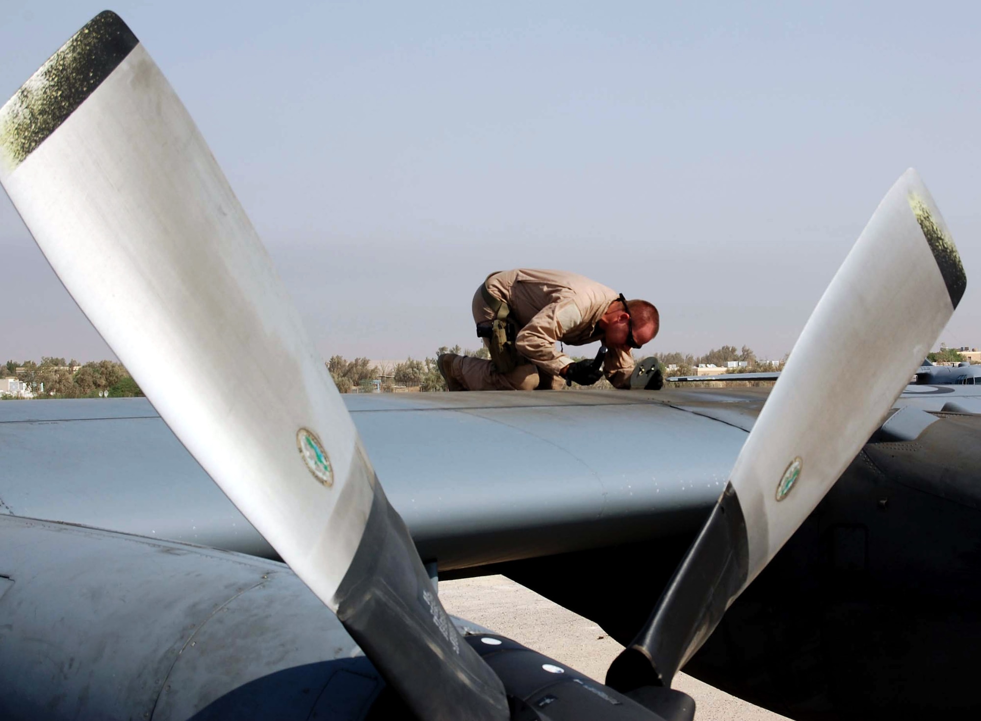 Tech. Sgt. Robert Kennedy inspects the left outboard motor bay of a C-130 Hercules prior to takeoff Oct. 11 on the 737th Expeditionary Airlift Squadron ramp. The check is part of the pre-flight inspection. Sergeant Kennedy is a 737th EAS flight engineer. (U.S. Air Force photo/Staff Sgt. Phillip Butterfield)