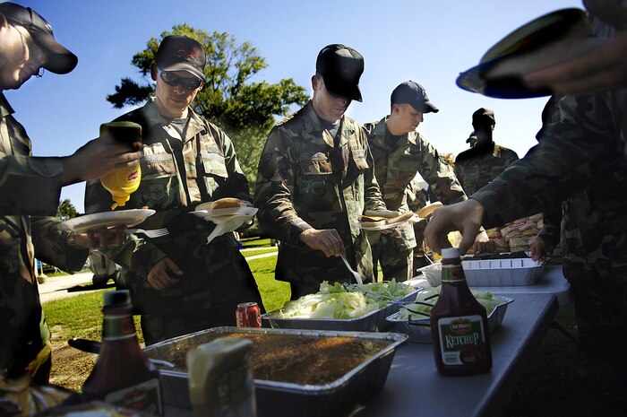 Airmen from the 437th and 315th Airlift Wings grab burgers and hotdogs during the Oktoberfest activities Oct. 12 at the dormitory area on Charleston AFB.  (U.S. Air Force photo/Airman 1st Class Nicholas Pilch)