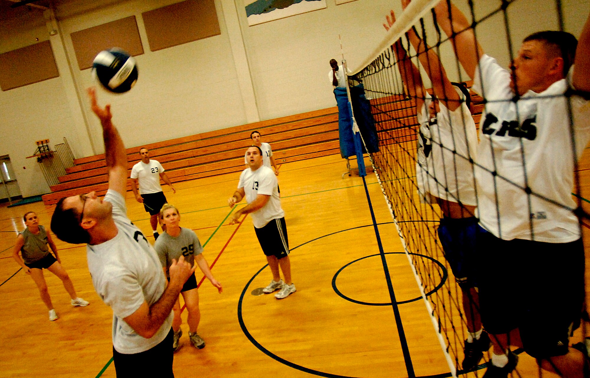 Daniel Tuller, Flyers/OSS, spikes the ball to the LRS team during the game at the Fitness and Sports Center Tuesday with Flyers/OSS beating LRS two games to zero. (U.S. Air Force photo/Airman 1st Class Nicholas Pilch)