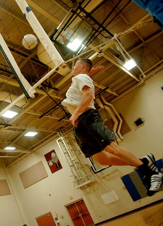Kelby Hagerla, Flyers/OSS team member, spikes the ball to the LRS team during their game at the Fitness and Sports Center. (U.S. Air Force photo/Airman 1st Class Nicholas Pilch)