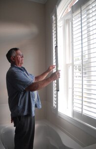 Ken Hoeft, contractor from K-N-K Industries in Michigan, measures blinds in one of the newly constructed houses on base Monday. The home is part of the Family Housing Phase IV construction project on base. (U.S. Air Force photo/Staff Sgt. Jennifer Arredondo)