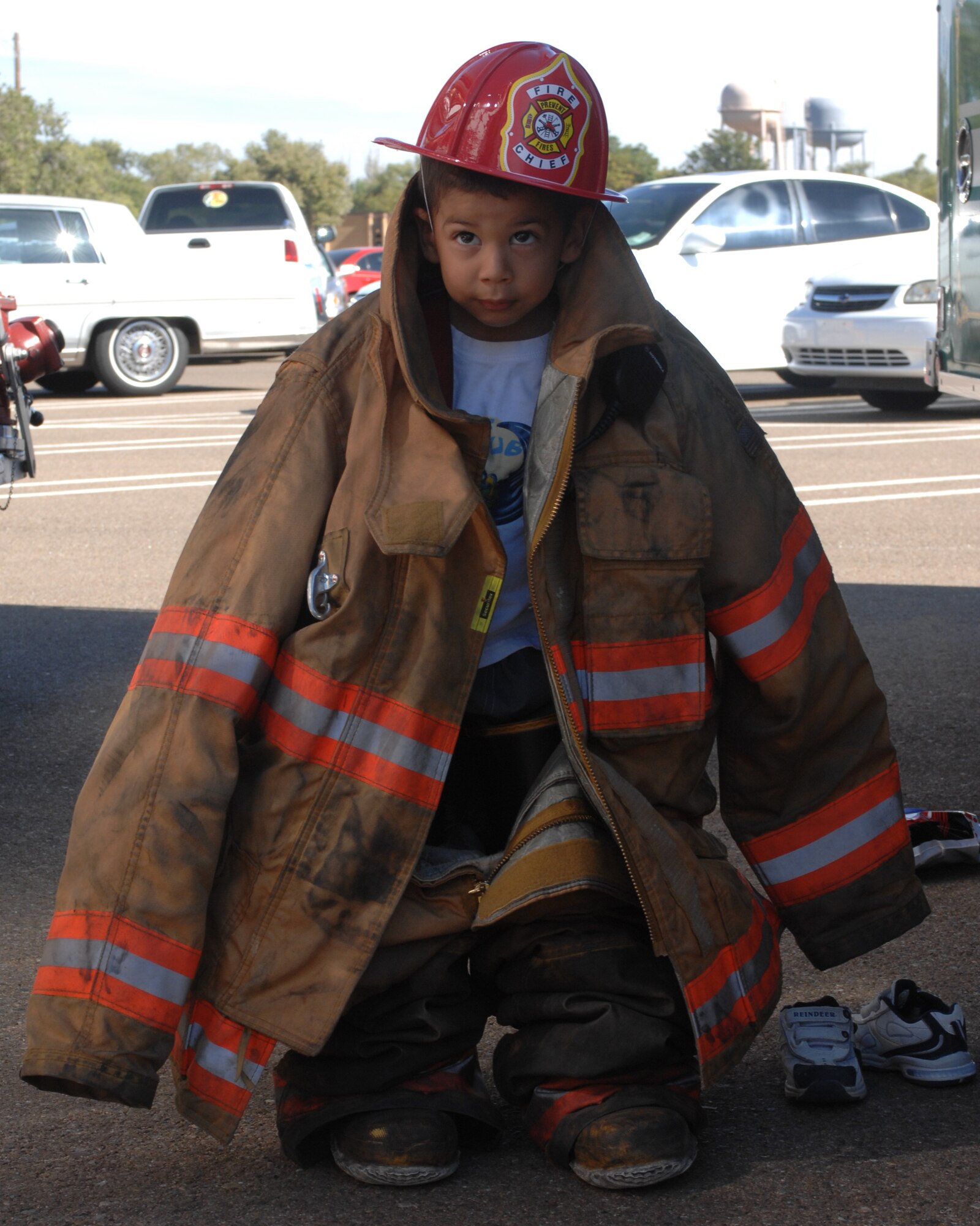 CANNON AIR FORCE BASE, N.M. -- Jake Dylan Quijano, son of Airman 1st Class Gilberto Quijano, 27th Special Operations Aeromedical Dental Squadron, tries on a fireman's suit during fire prevention week. The theme of fire prevention week was have an escape plan. (U.S. Air Force photo by Airman 1st Class Evelyn Chavez)