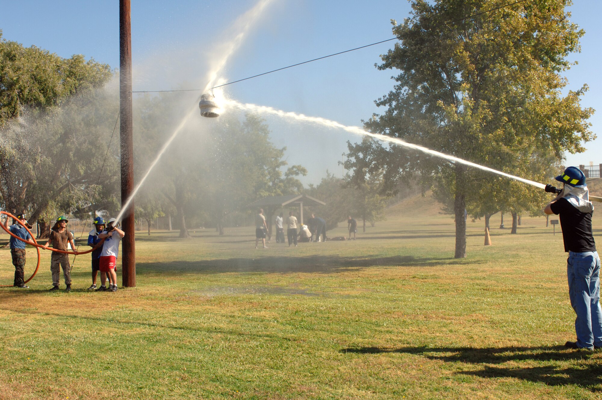 CANNON AIR FORCE BASE, N.M. -- Two teams compete in waterball at the fire muster during fire prevention week. The theme of fire prevention week was have an escape plan. (U.S. Air Force photo by Airman 1st Class Evelyn Chavez)