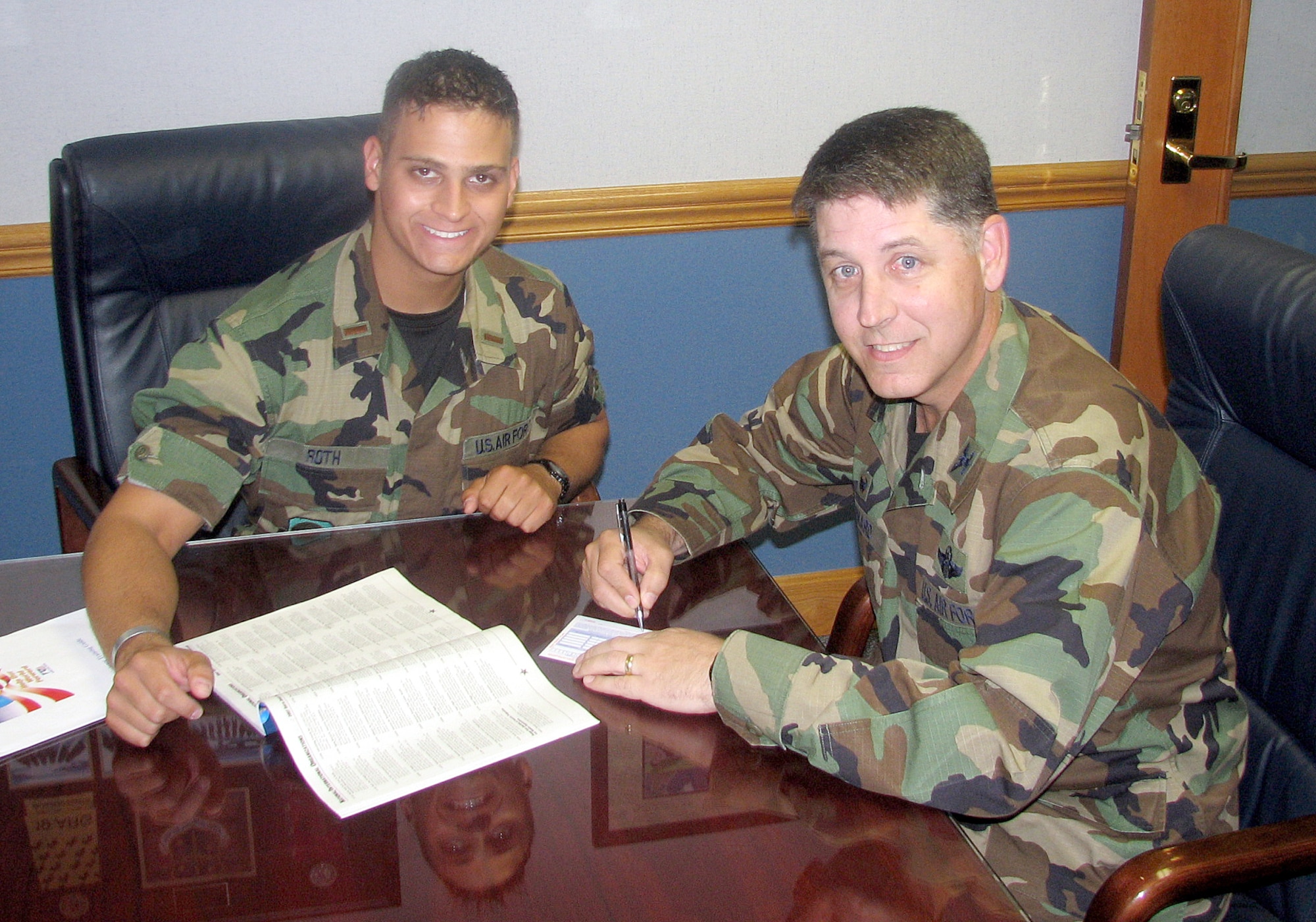 Col. Steven Bernard, 621st Contingency Response Wing commander, makes a contribution to the Team McGuire 2007 Combined Federal Campaign. To his left is 2nd Lt. Kevin Roth, alternate CFC point of contact for the 621st CRW. (U.S. Air Force/courtesy photo)