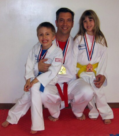 Maj. George Unsinger, 437th Maintenance Squadron commander, and his children, Ryan, 8, and Katie, 5, bring home awards from the 17th Annual Tae Kwon Do Governor?s Cup which was held in Greenville, S.C., Sept. 29. (Courtesy photo)