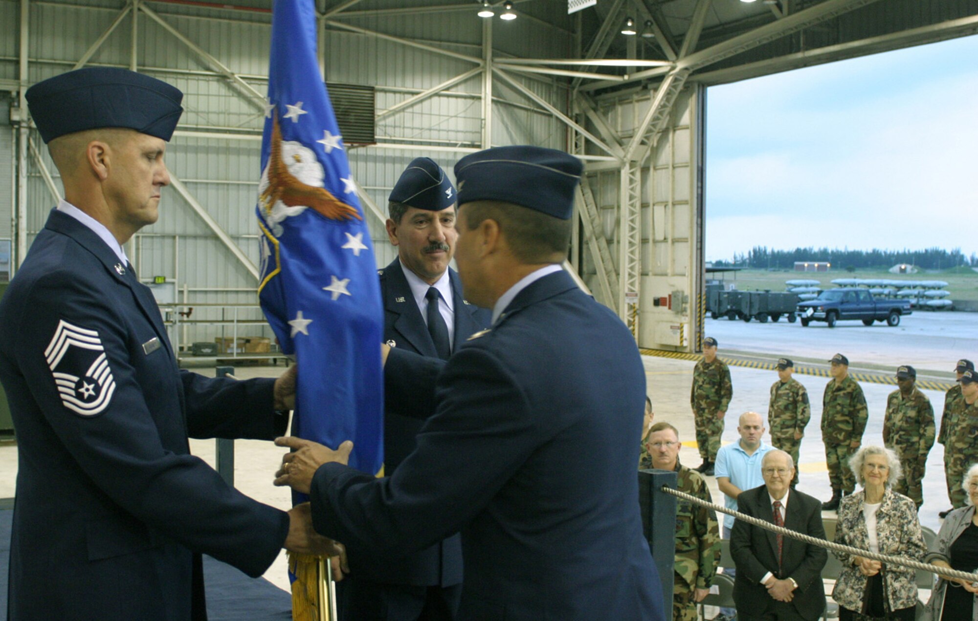 Col. Randy Falcon, commander of the 482nd Fighter Wing, accepts the guidon of the 482nd Maintenance Group from Chief Master Sgt. Kevin Stickley, chief enlisted manager of the 482nd Fighter Wing Maintenance Group. The guidon, and command of the maintenance group, then passed to Col. M.J. Giddings Jr. in an assumption of command ceremony Oct. 14. (U.S. Air Force photo/Tech. Sgt. Paul Dean)