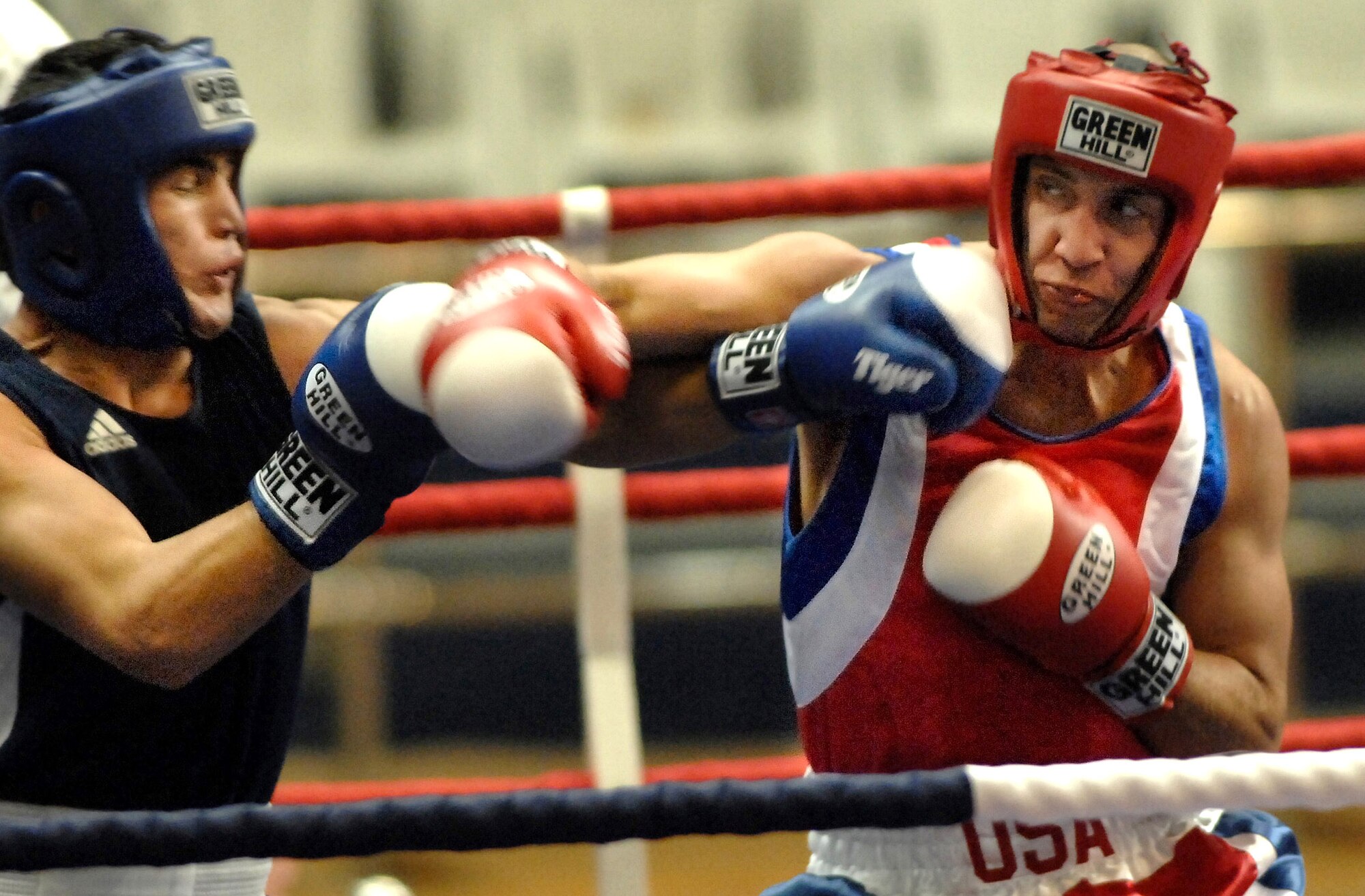 Army Capt. Boyd Melson (right) throws a right hook against Pvt. Hudaynazarov Rawshan of Uzbekistan during the Military World Games Boxing competition Oct. 15 in Hyderabad, India. The Conseil Internationale du Sport Militaire's Military World Games event is the largest international military Olympic-style event in the world. In this year's fourth edition of the Games, 103 countries and more than 5,000 athletes are scheduled to compete Oct. 14 through 21 in boxing, diving, soccer, handball, judo, military pentathlon, parachuting, sailing, shooting, swimming, volleyball and track and field. The purpose of the Military World Games is to promote friendship through sport. (U.S. Air Force photo/Tech. Sgt. Cecilio Ricardo Jr.) 
