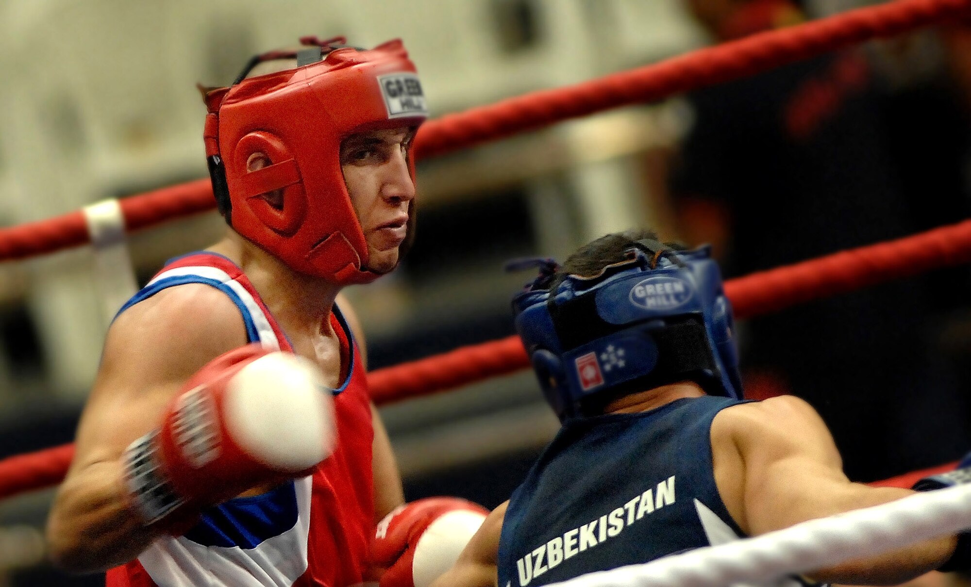Army Capt. Boyd Melson (left) throws a right hook against Pvt. Hudaynazarov Rawshan of Uzbekistan during the Military World Games Boxing competition Oct. 15 in Hyderabad, India. The Conseil Internationale du Sport Militaire's Military World Games event is the largest international military Olympic-style event in the world. In this year's fourth edition of the Games, 103 countries and more than 5,000 athletes are scheduled to compete Oct. 14 through 21 in boxing, diving, soccer, handball, judo, military pentathlon, parachuting, sailing, shooting, swimming, volleyball and track and field. The purpose of the Military World Games is to promote friendship through sport. (U.S. Air Force photo/Tech. Sgt. Cecilio Ricardo Jr.) 
