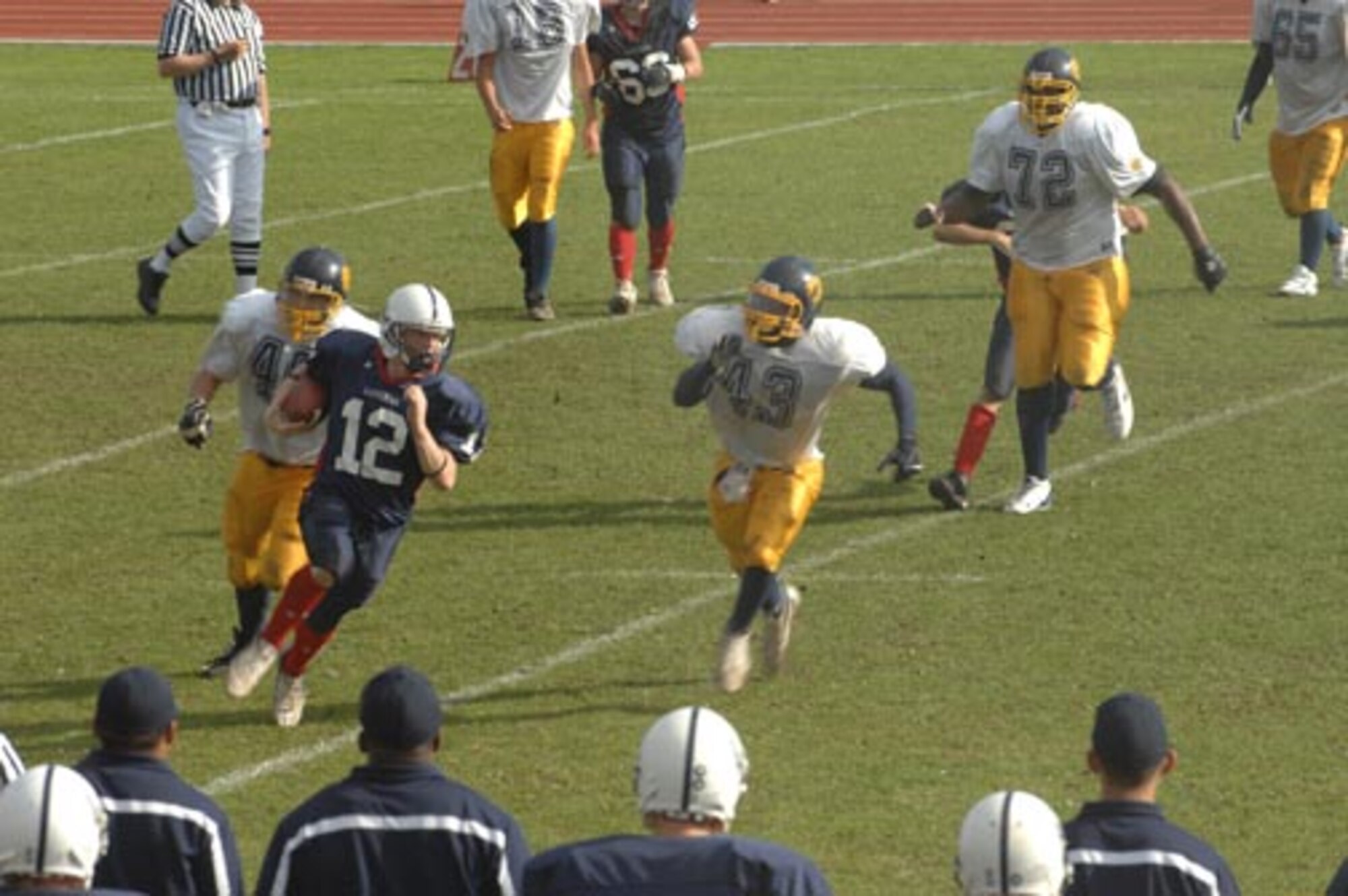Nate Allison of the Lakenheath High School Lancers is chased downfield by the Heidelberg High School Lions after receiving a pass during the homecoming game Oct. 13. The Lions took the Lancers for the victory 27-14. (U.S. Air Force photo by Airman 1st Class John Easterling)