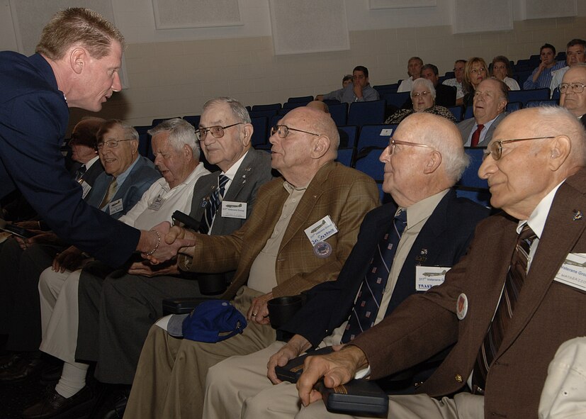 Colonel Kevin Jackson, 317th Airlift Group commander, congratulates members of the 317th Troop Carrier Group during an award ceremony in St. Louis, Mo., Oct. 5. Colonel Jackson attended the event to present more than 20 World War II Jungle Skippers with the Asiatic-Pacific Campaign and Bronze Star Medals for actions they performed in 1944. (Courtesy photo)