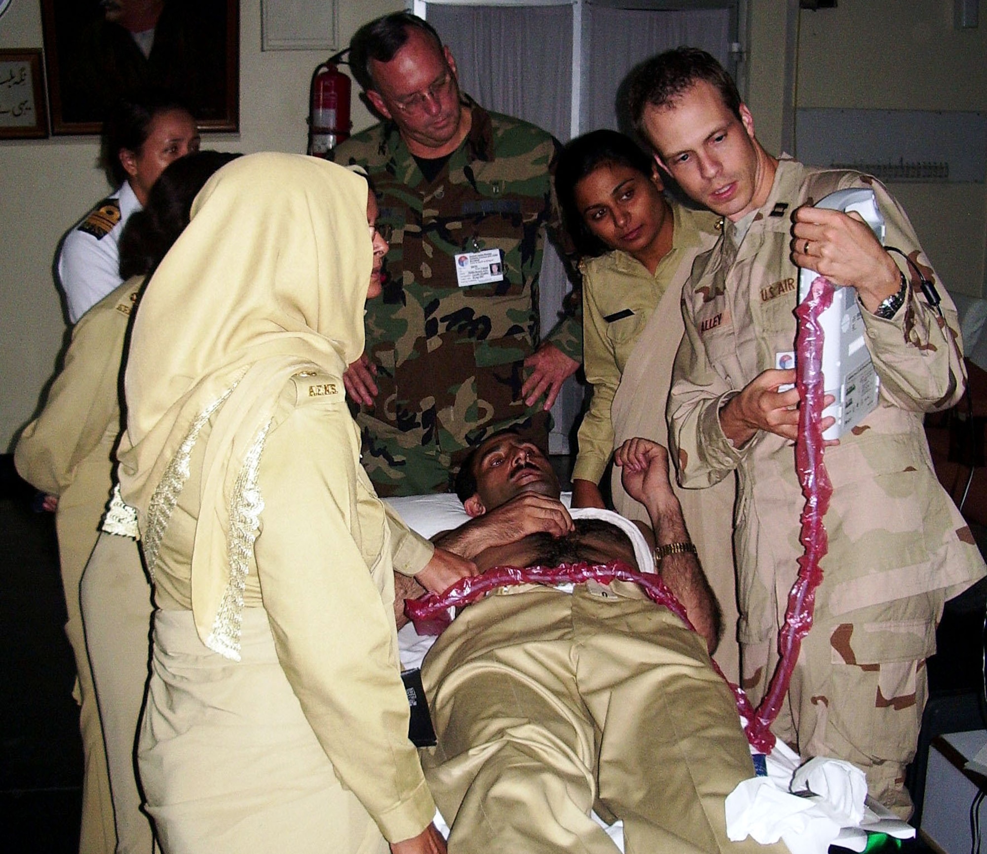 Capt. (Dr.) Josh Alley (right) teaches Pakistani nurses how to use ultrasound for trauma patients, as Lt. Col. (Dr.) William Brian Perry looks on. Three doctors from the 59th Medical Wing recently served as volunteer instructors for a five-day medical course in Rawalpindi, Pakistan, to teach host nation medical professionals advanced surgery techniques for trauma patients either from natural disasters or war. Captain Alley is a general surgeon from Wilford Hall Medical Center. (U.S. Air Force photo/Lt. Col. (Dr.) Todd Rasmussen)